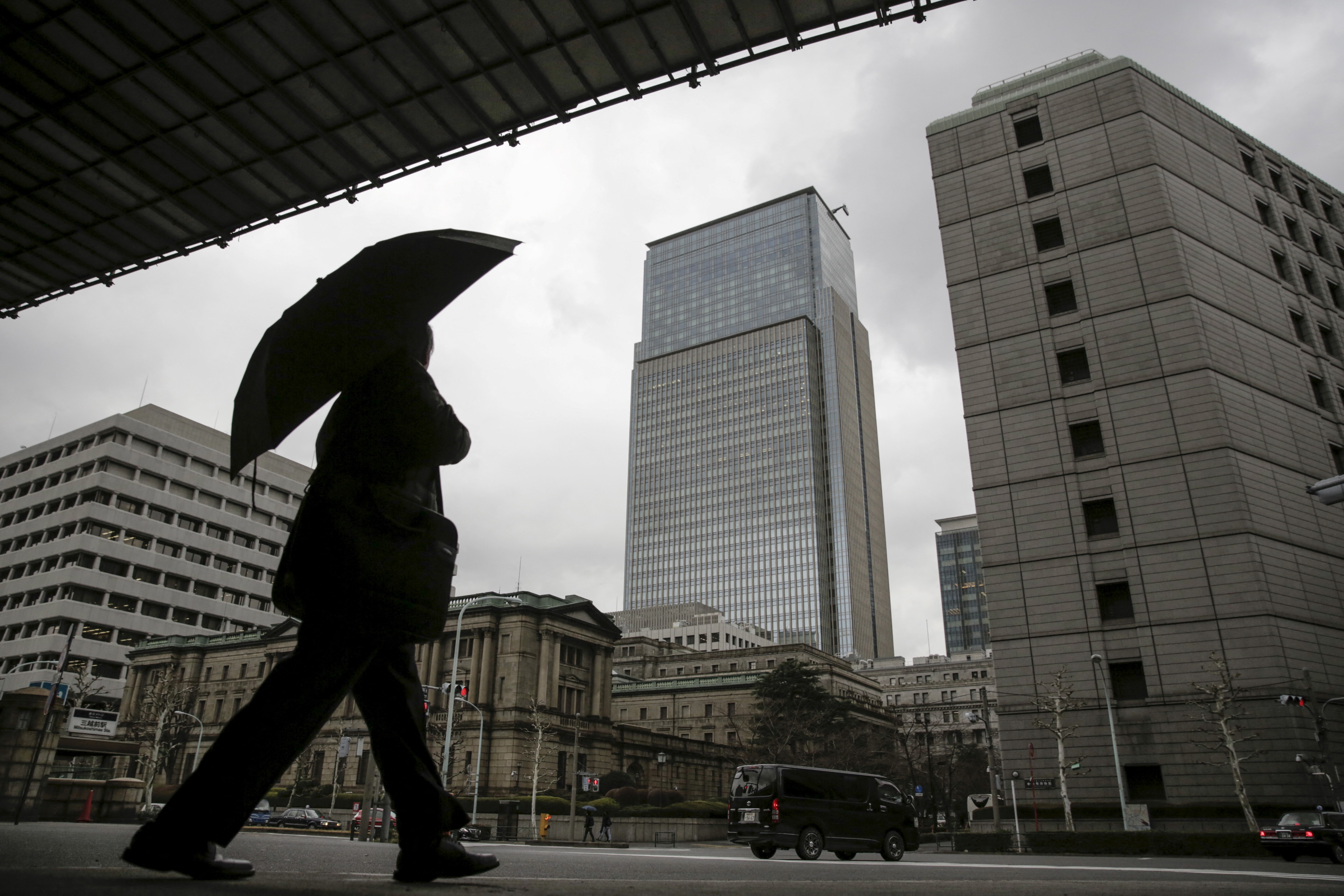 A businessman walks near the Bank of Japan headquarters in Tokyo