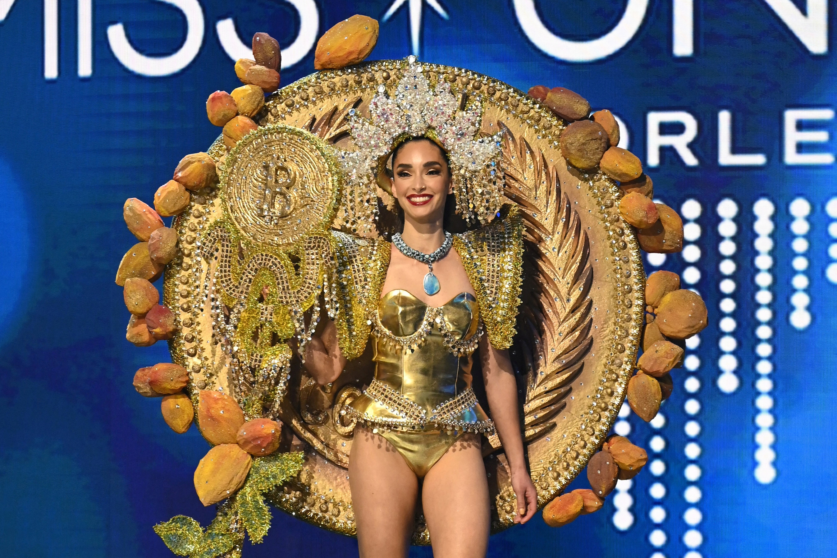 Alejandra Guajardo, Miss Universe El Salvador 2022 poses on stage in an outfit inspired by the country's use of Bitcoin as a currency