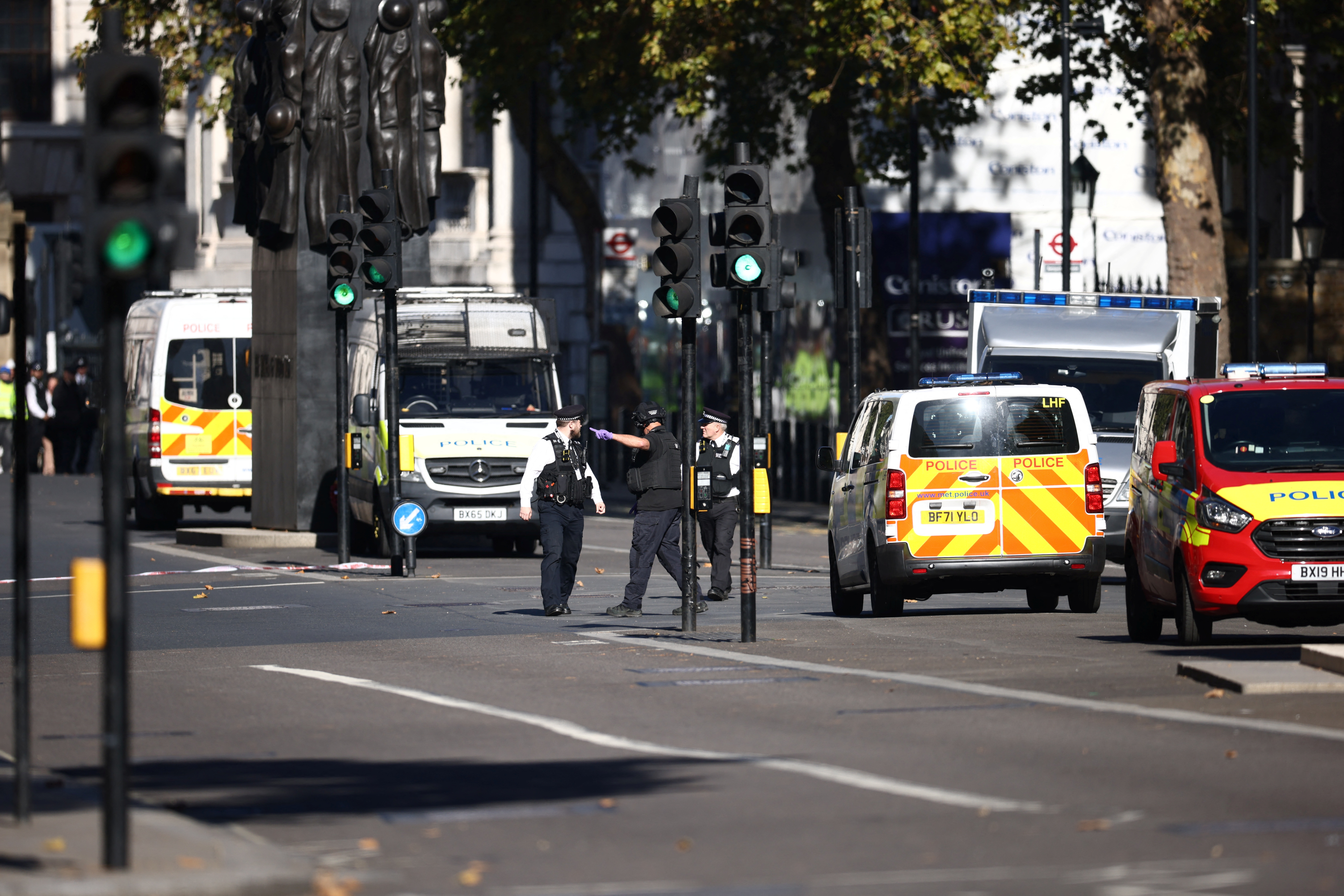 Members of the police work after a suspicious package was found, at Whitehall