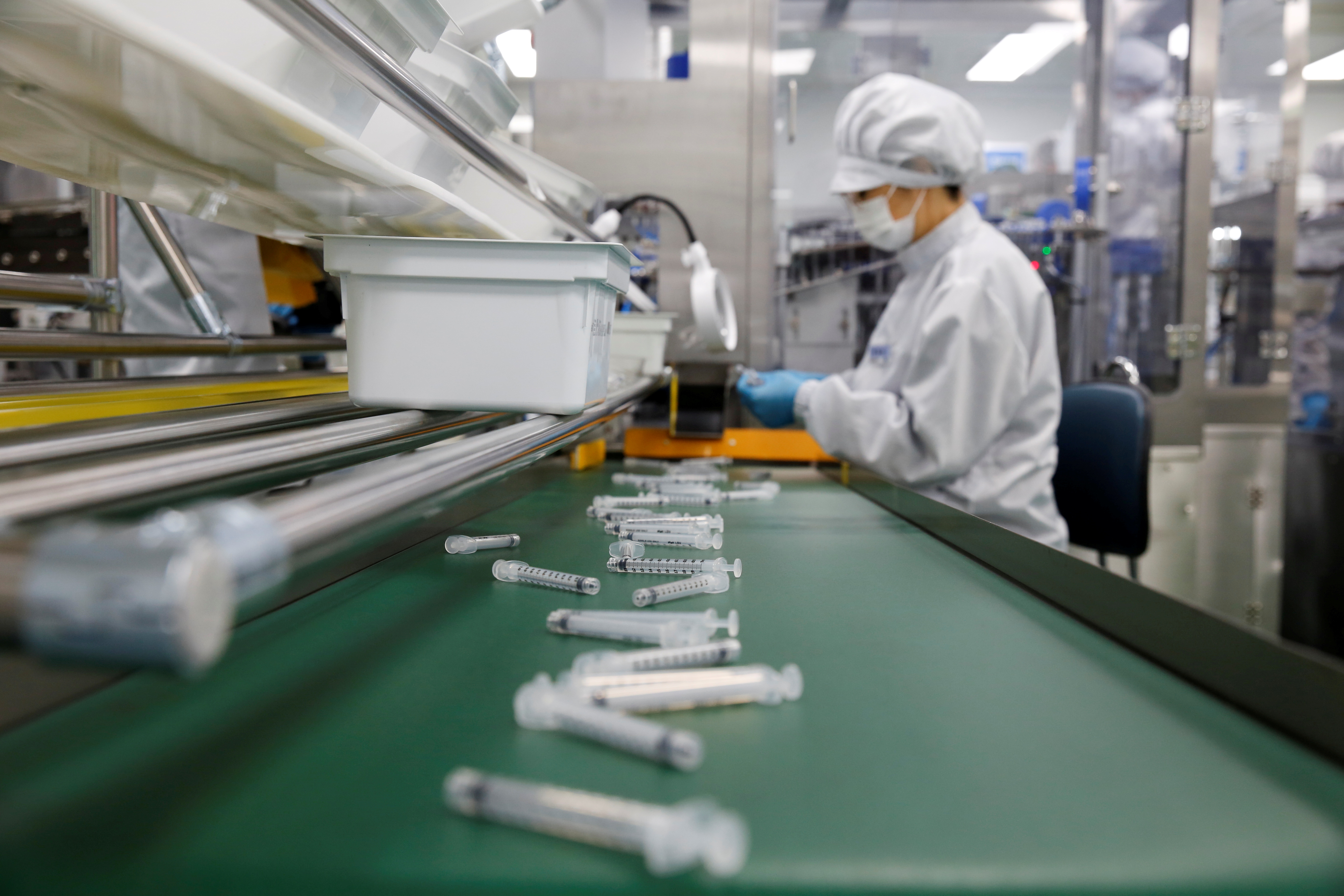 An employee works in an assembly line at a low dead space (LDS) syringe factory in Gunsan