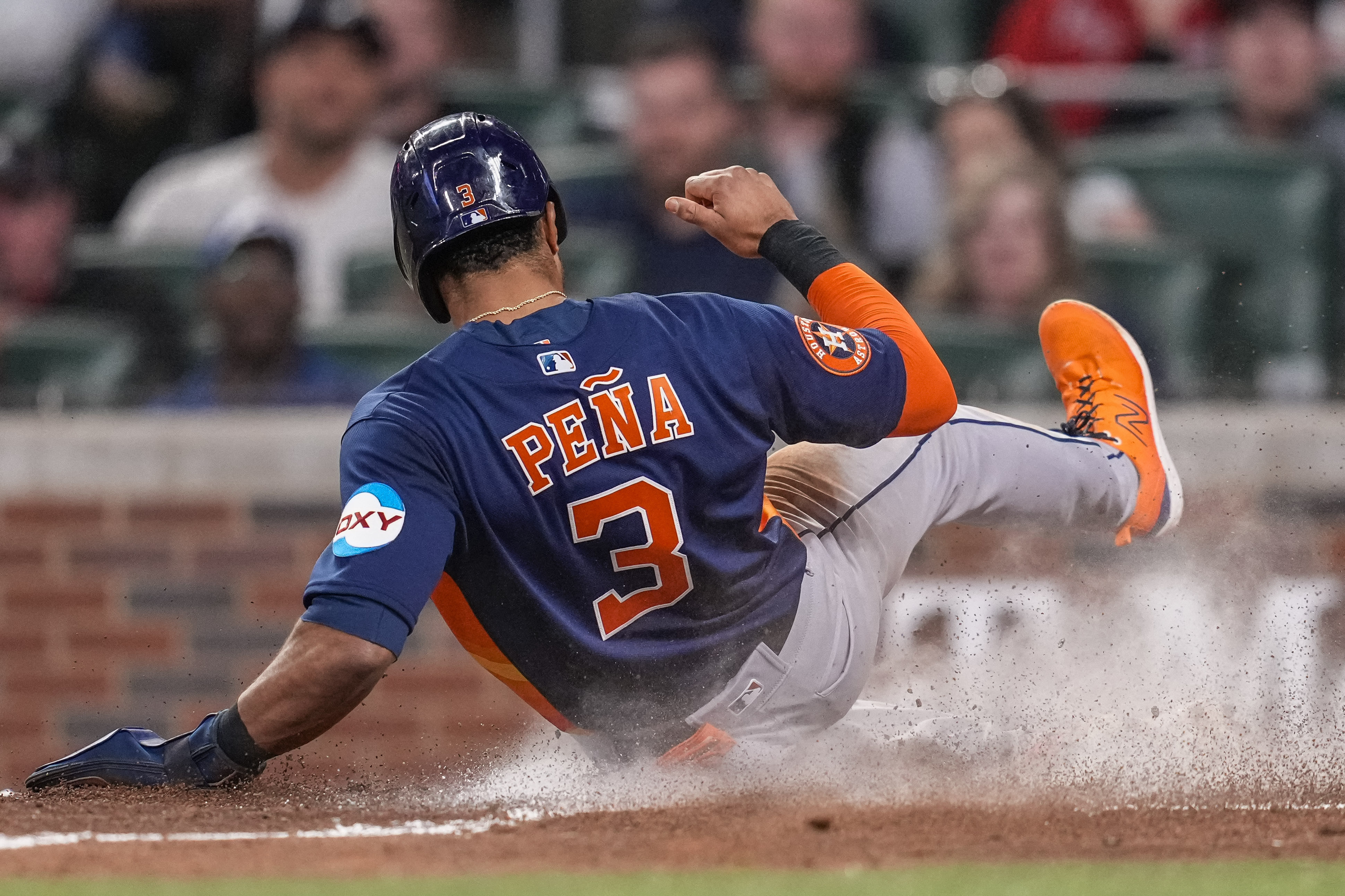 Houston Astros' Kyle Tucker is safe at second on a fielding error by  Atlanta Braves second baseman Ozzie Albies during the sixth inning in Game  2 of baseball's World Series between the