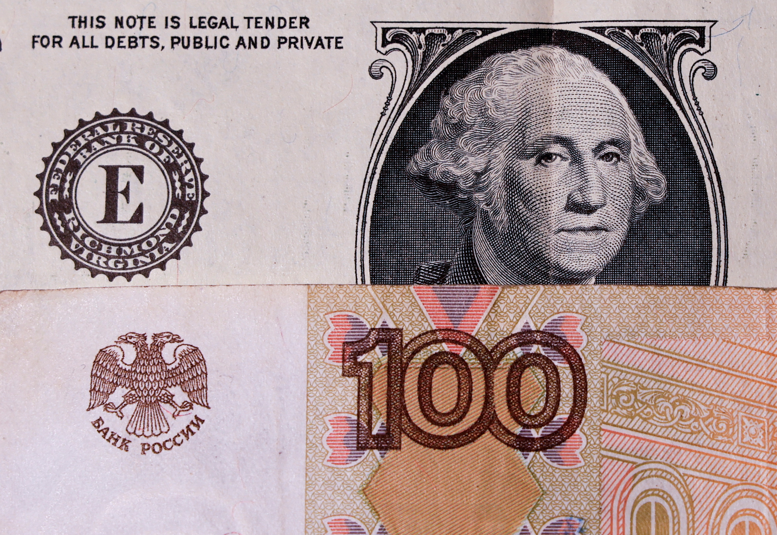 Illustration shows U.S. dollar and Russian rouble banknotes