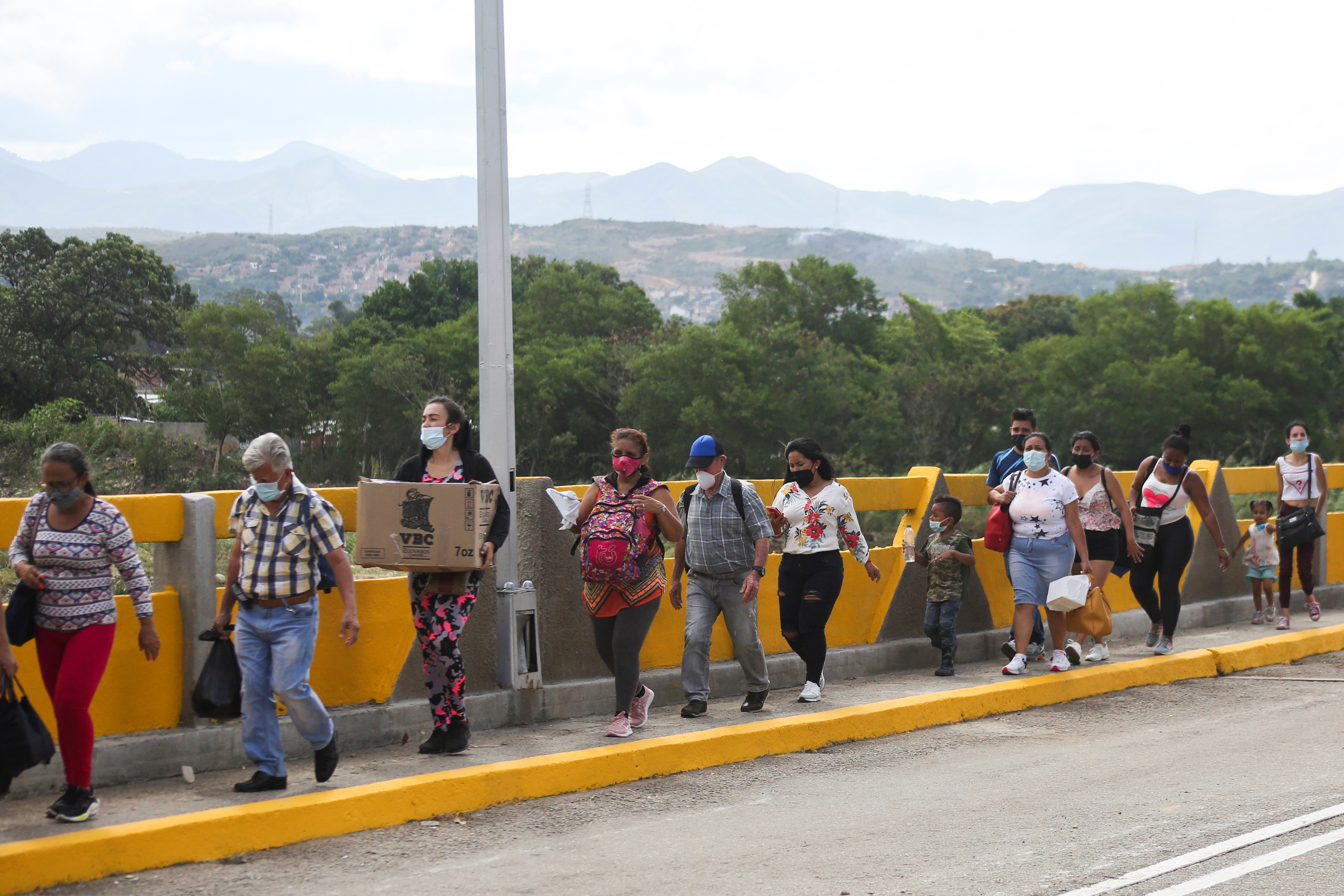 People, permitted for humanitarian reasons, cross the Simon Bolivar International bridge from Cucuta, Colombia, after it was reopened, as seen from in San Antonio del Tachira, Venezuela October 4, 2021. REUTERS/Carlos Eduardo Ramirez