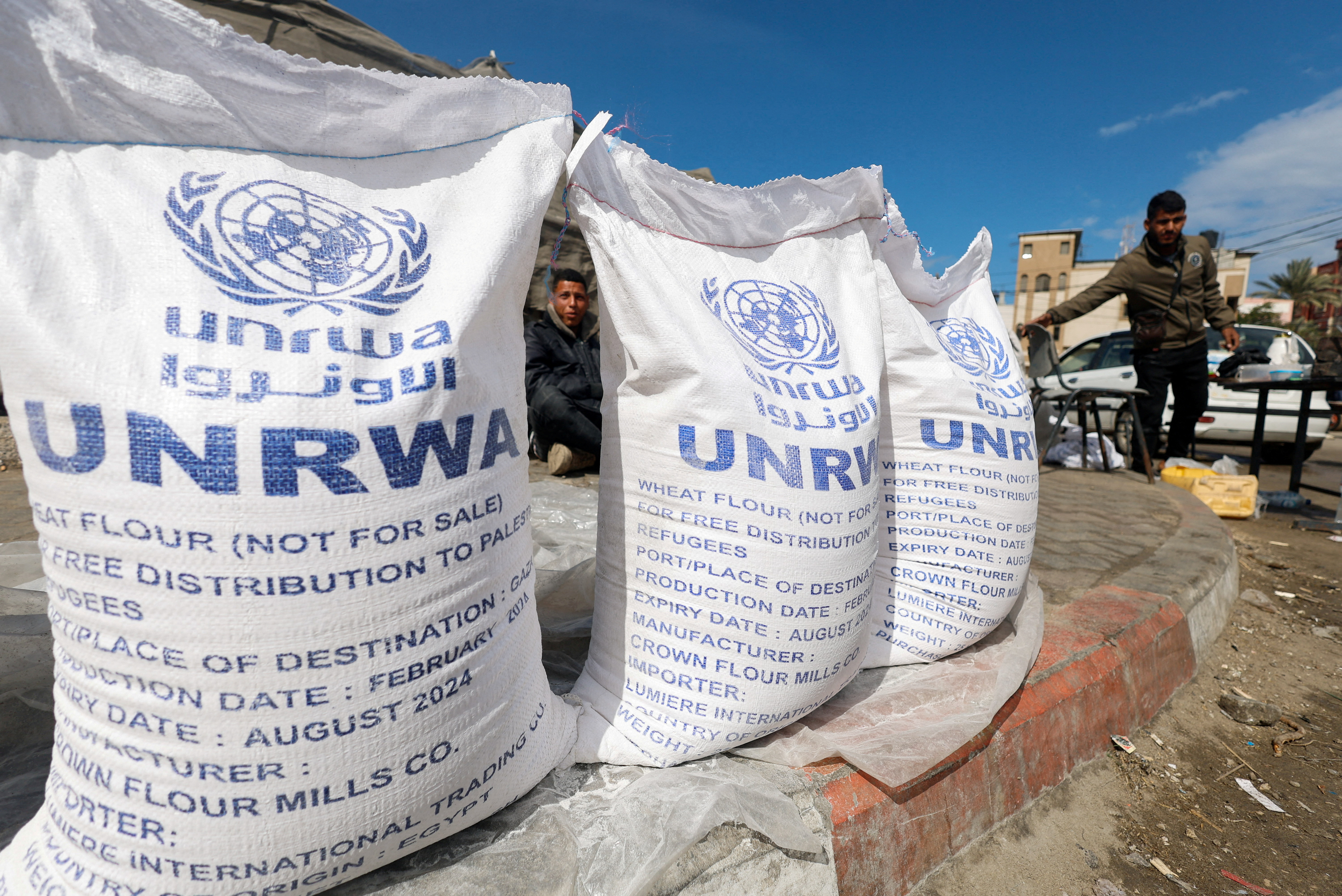 Displaced Palestinians wait to receive United Nations Relief and Works Agency (UNRWA) aid, in Rafah