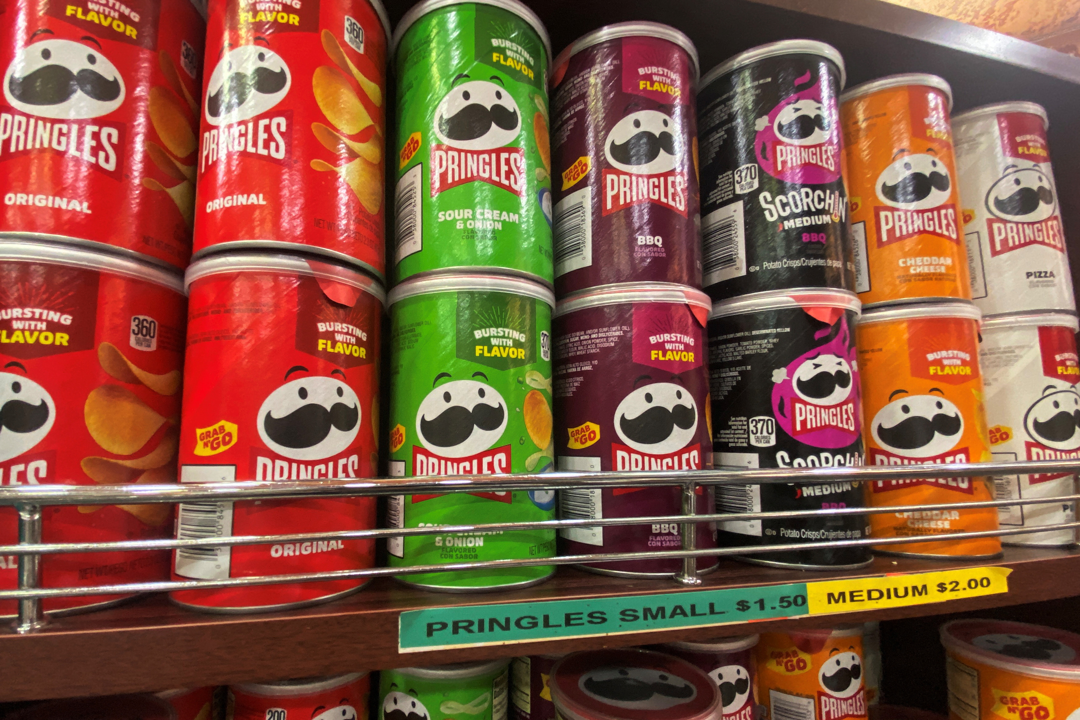 Cans of flavoured Pringles are seen on display at a store in New York City