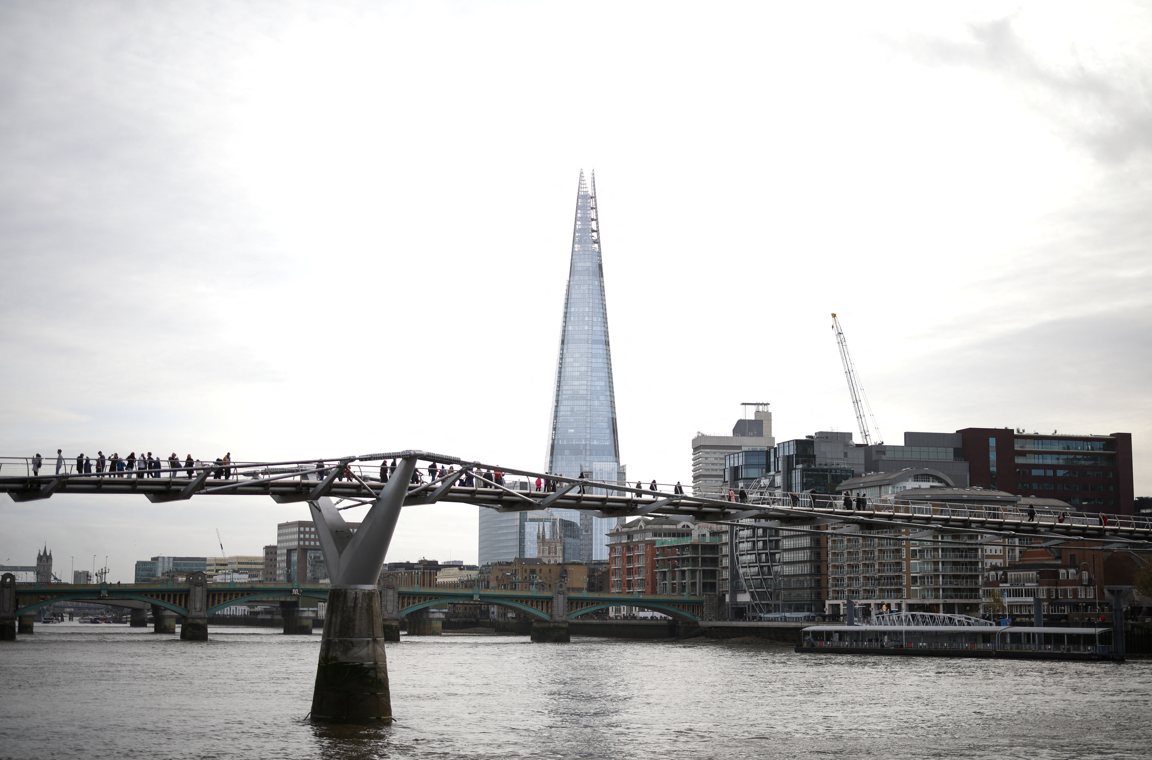 People walk near The Shard building, owned by the State of Qatar, in London