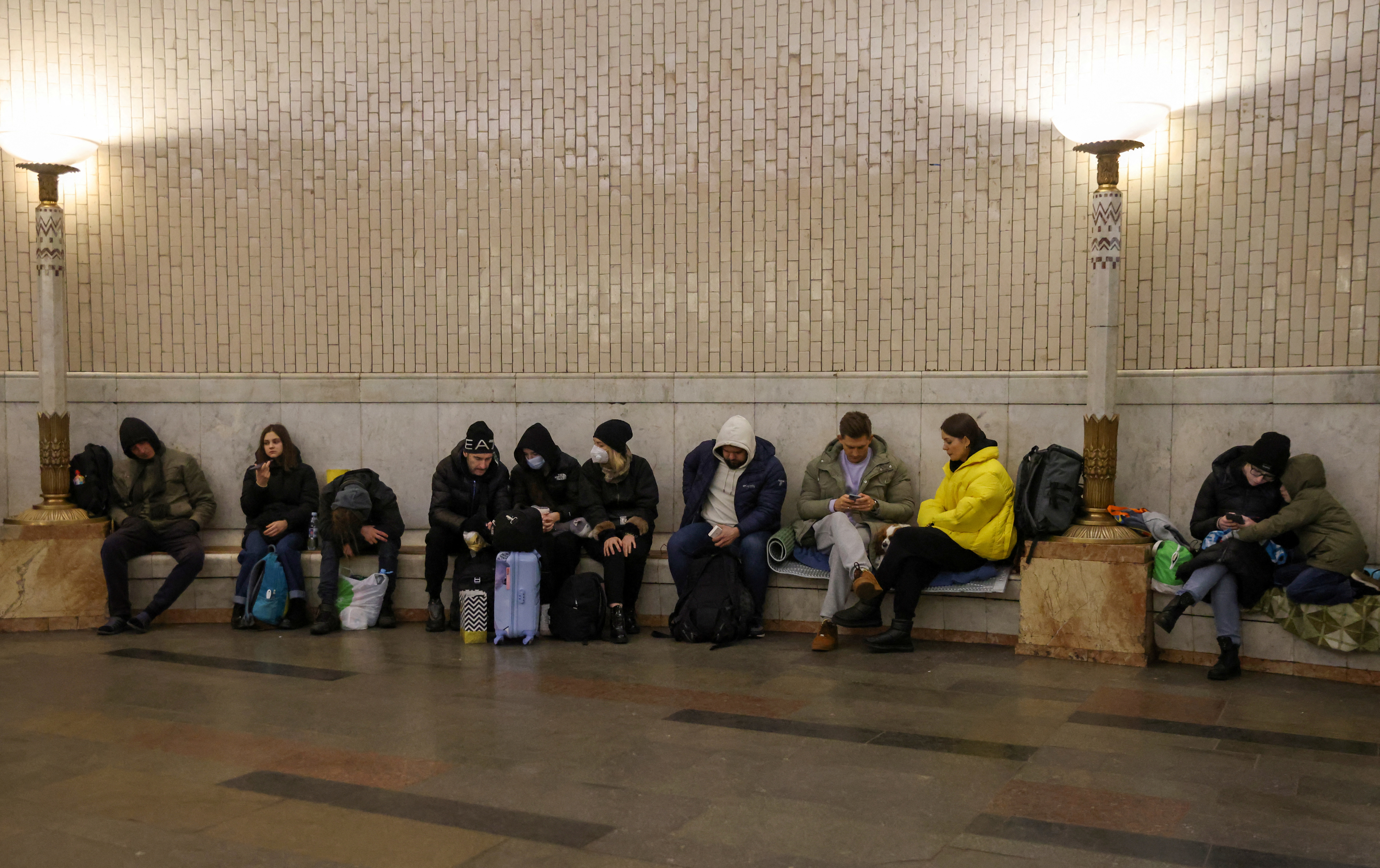 People gather at a metro station as they seek shelter from expected Russian air strikes, in Kyiv