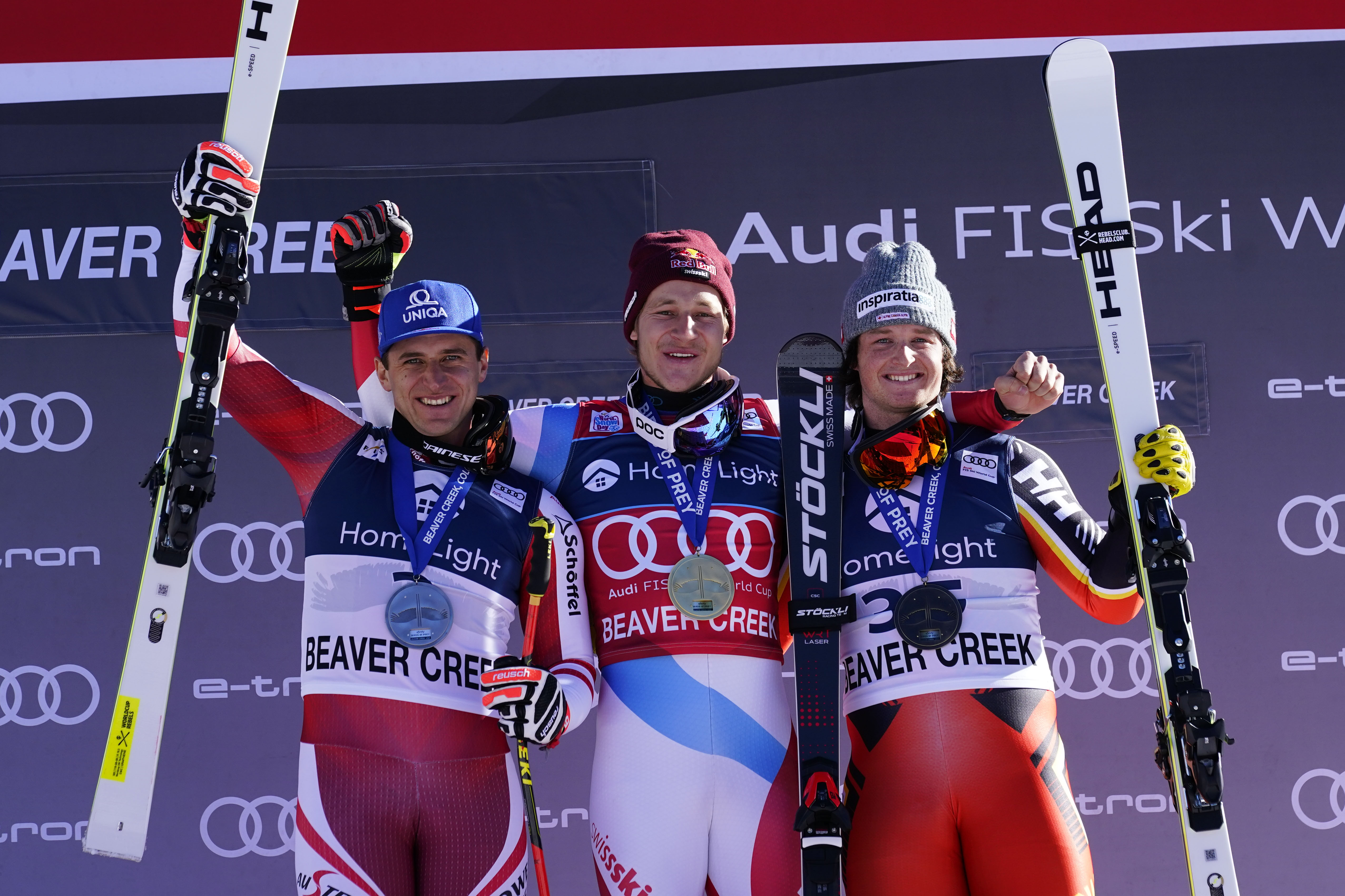 Dec 2, 2021; Beaver Creek, Colorado, USA; Second place Matthias Mayer of Austria (left), first place Marco Odermatt of Switzerland (center), and third place Broderick Thompson of Canada (right) pose for photos on the podium during first of two men's Super G races at the Birds of Prey FIS alpine skiing World Cup at Beaver Creek. Mandatory Credit: Michael Madrid-USA TODAY Sports