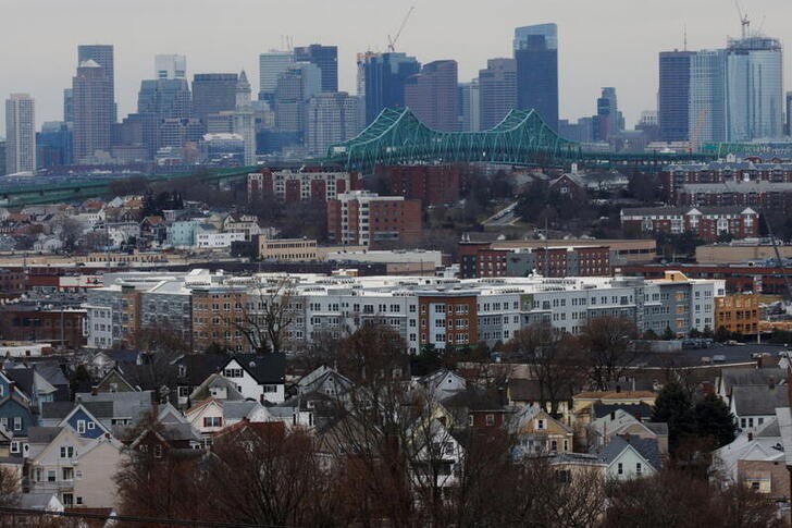 The Boston skyline stands behind the Tobin Bridge and the city of Chelsea as seen from Everett