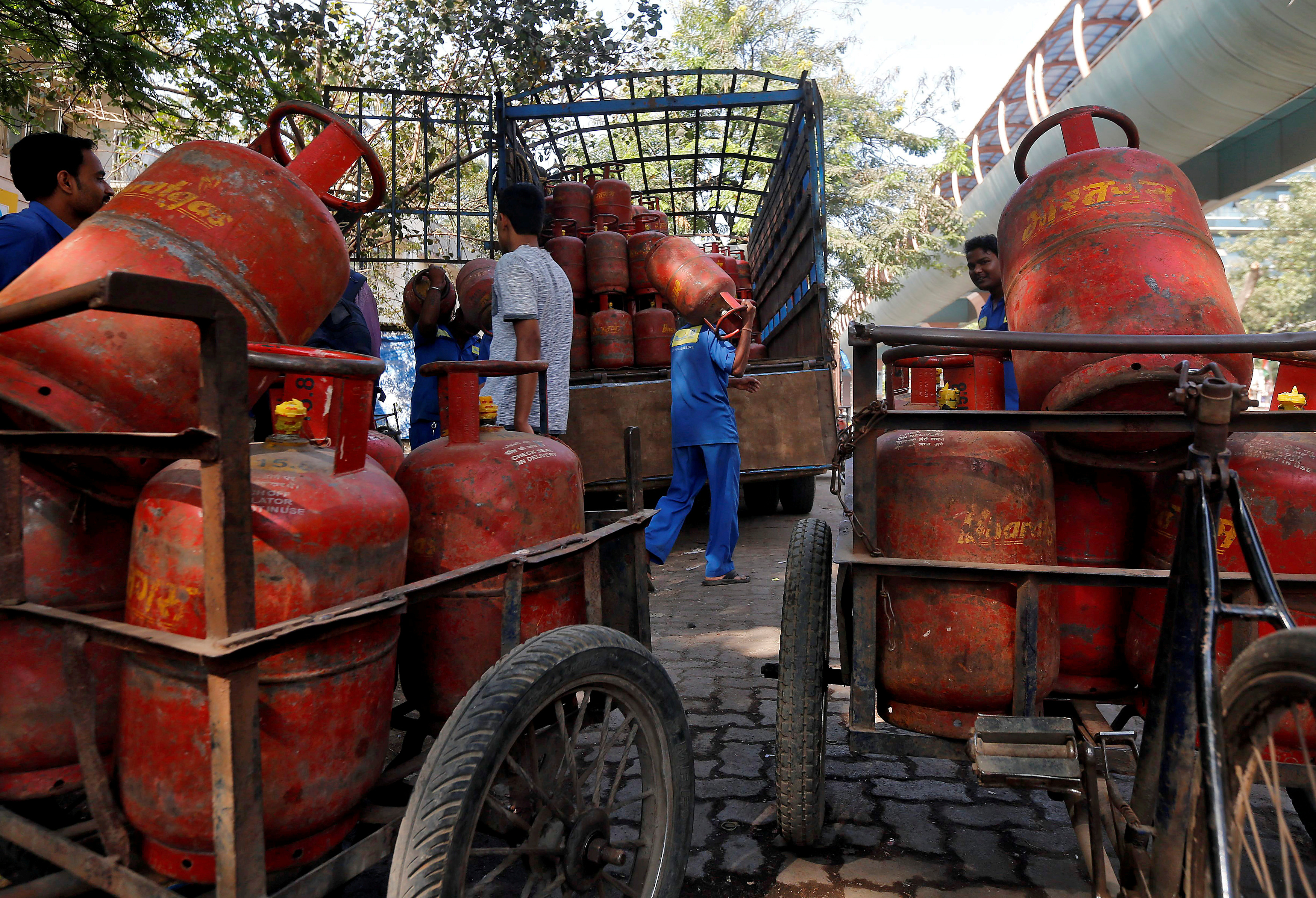 Workers load LPG cooking cylinders onto a supply truck outside a distribution centre in Mumbai