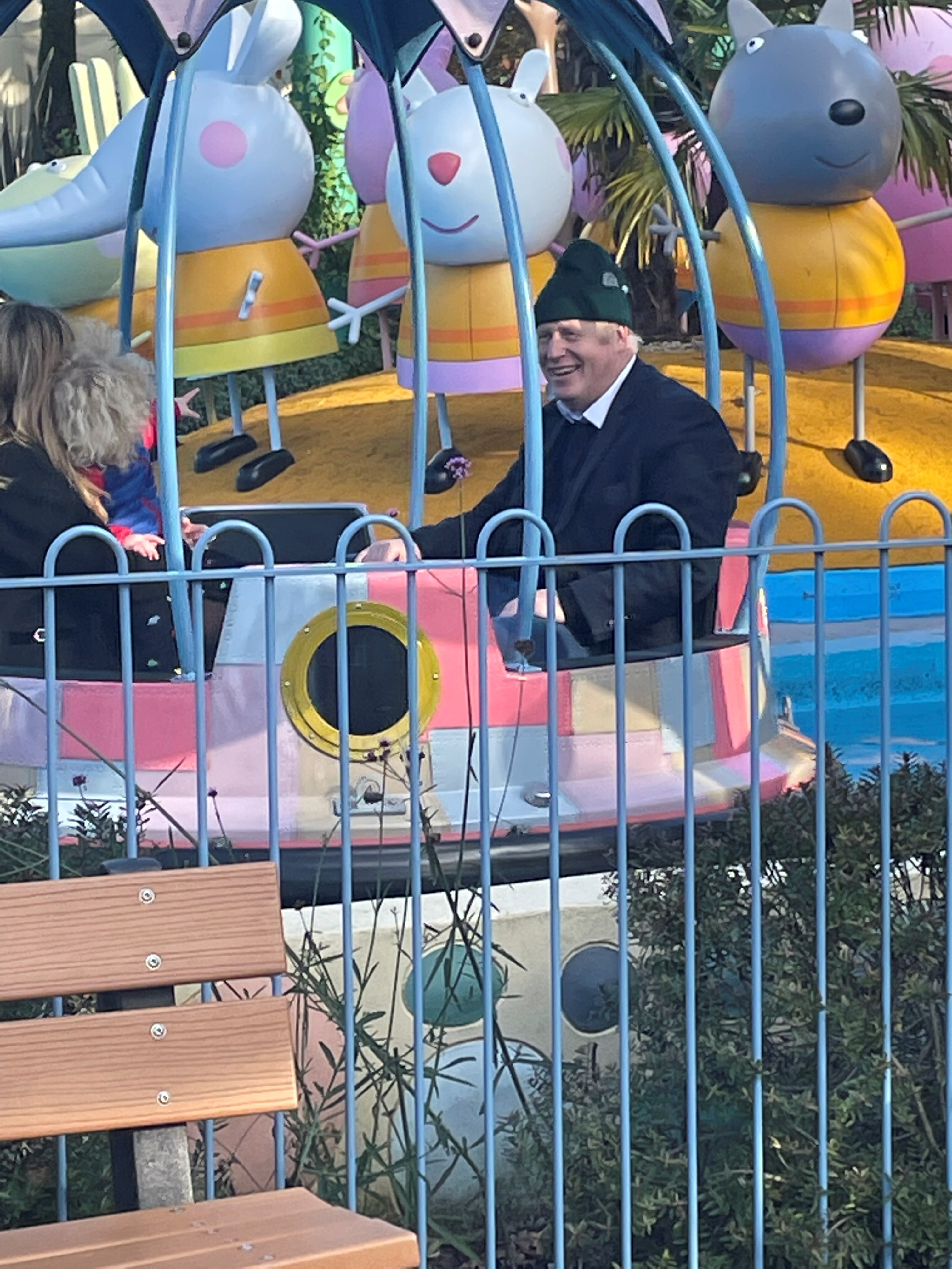 Britain's Prime Minister Boris Johnson enjoys a ride with his wife Carrie Johnson and son at Peppa Pig World near Ower