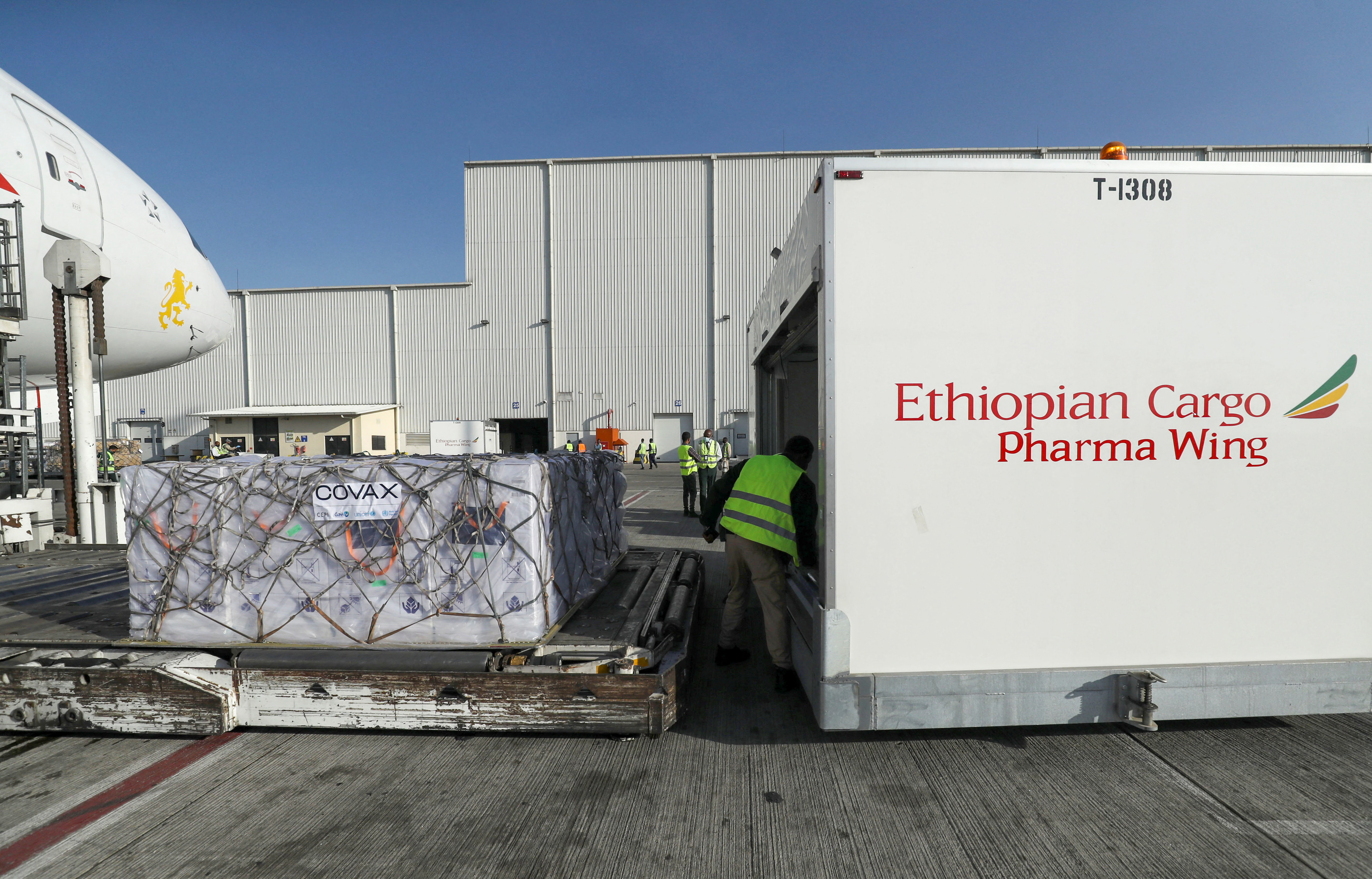 An Ethiopian Airlines staff unloads the AstraZeneca/Oxford vaccines from a cargo plane at the Bole International Airport in Addis Ababa