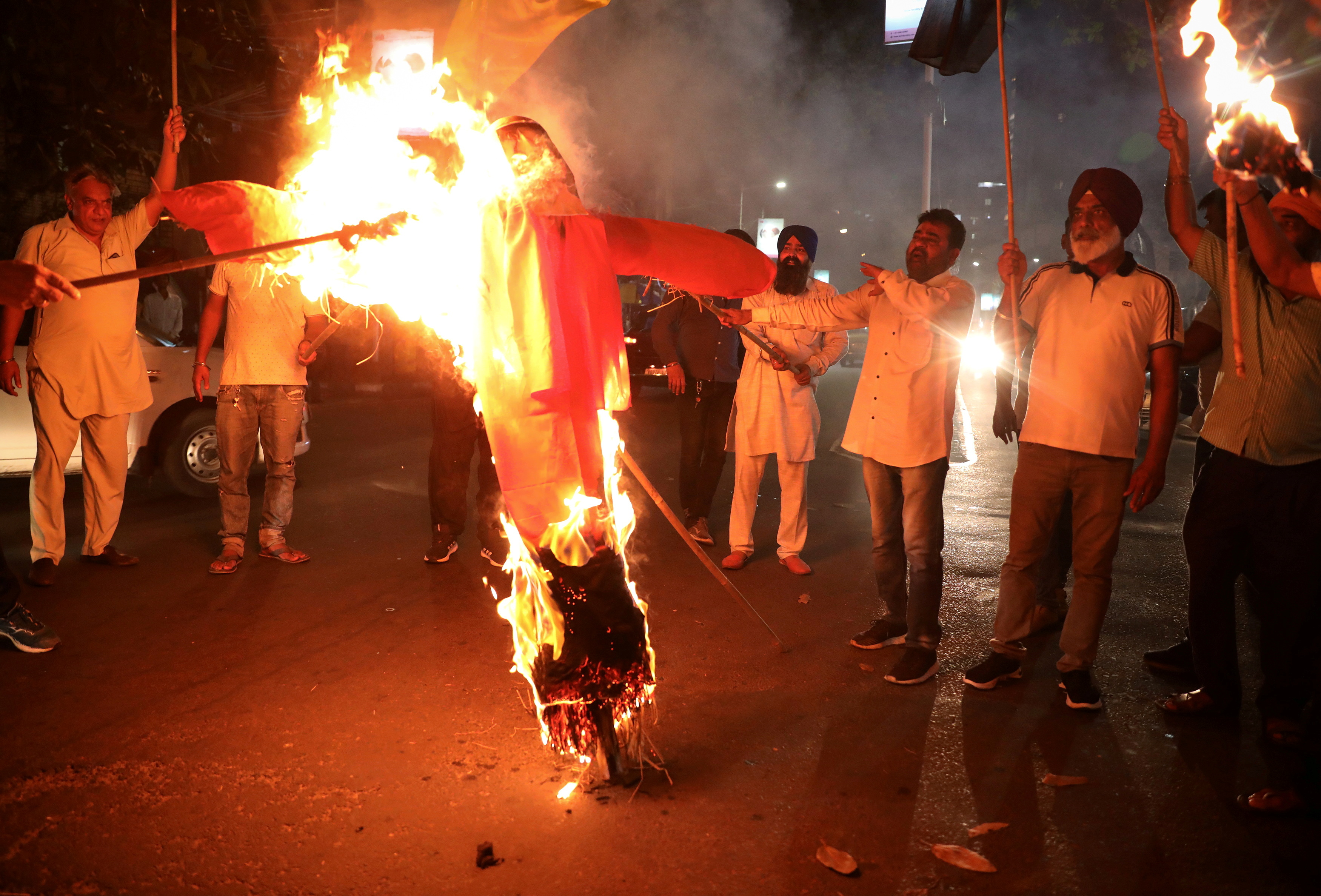 Protestors burn an effigy of Yogi Adityanath, Chief Minister of the northern state of Uttar Pradesh, during a protest after people were killed when a car linked to a federal minister ran over farmers protesting against controversial farm laws in Uttar Pradesh on Sunday, in Kolkata, India, October 4, 2021. REUTERS/Rupak De Chowdhuri