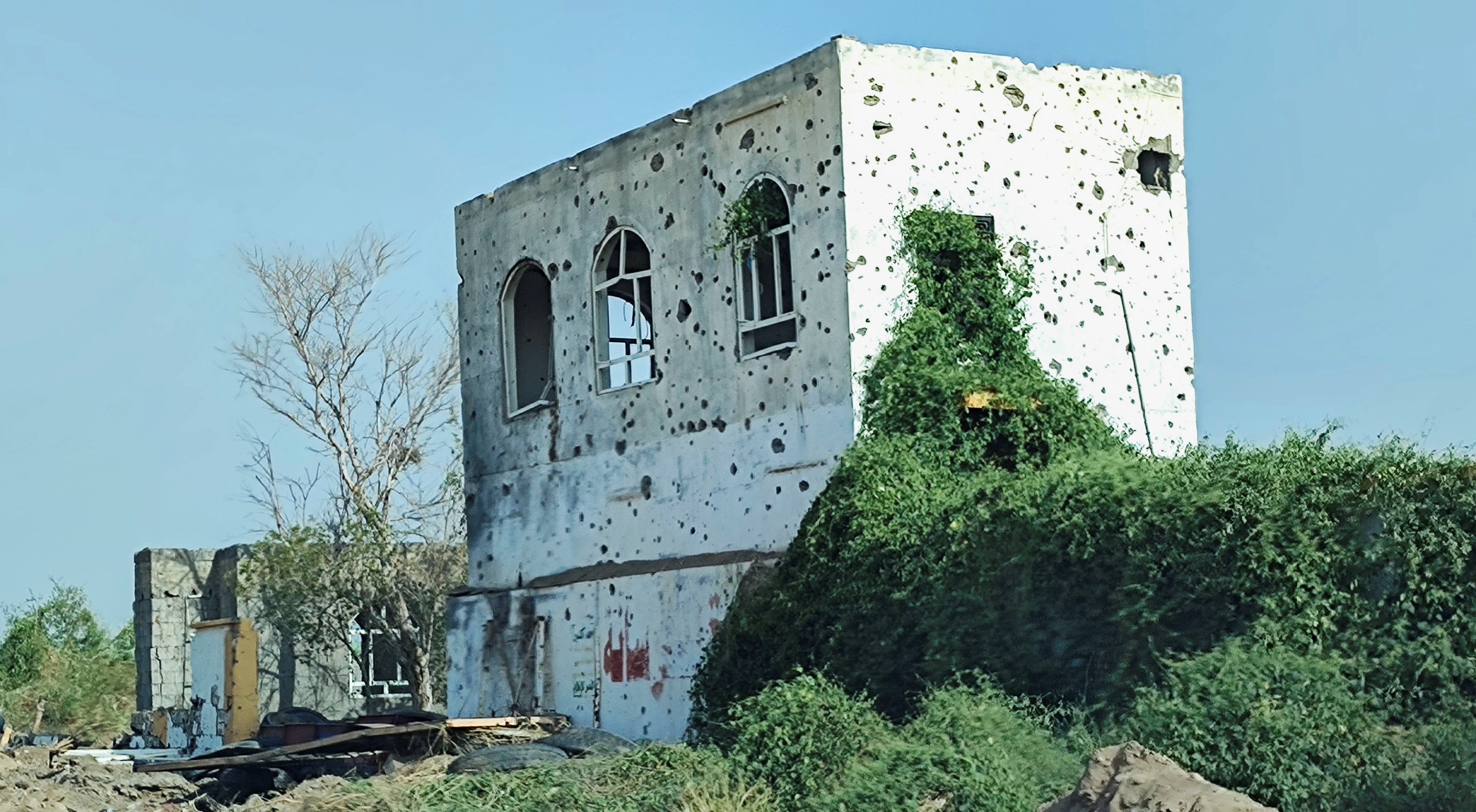 Buildings damaged by clashes are seen on the outskirts of Hodeidah
