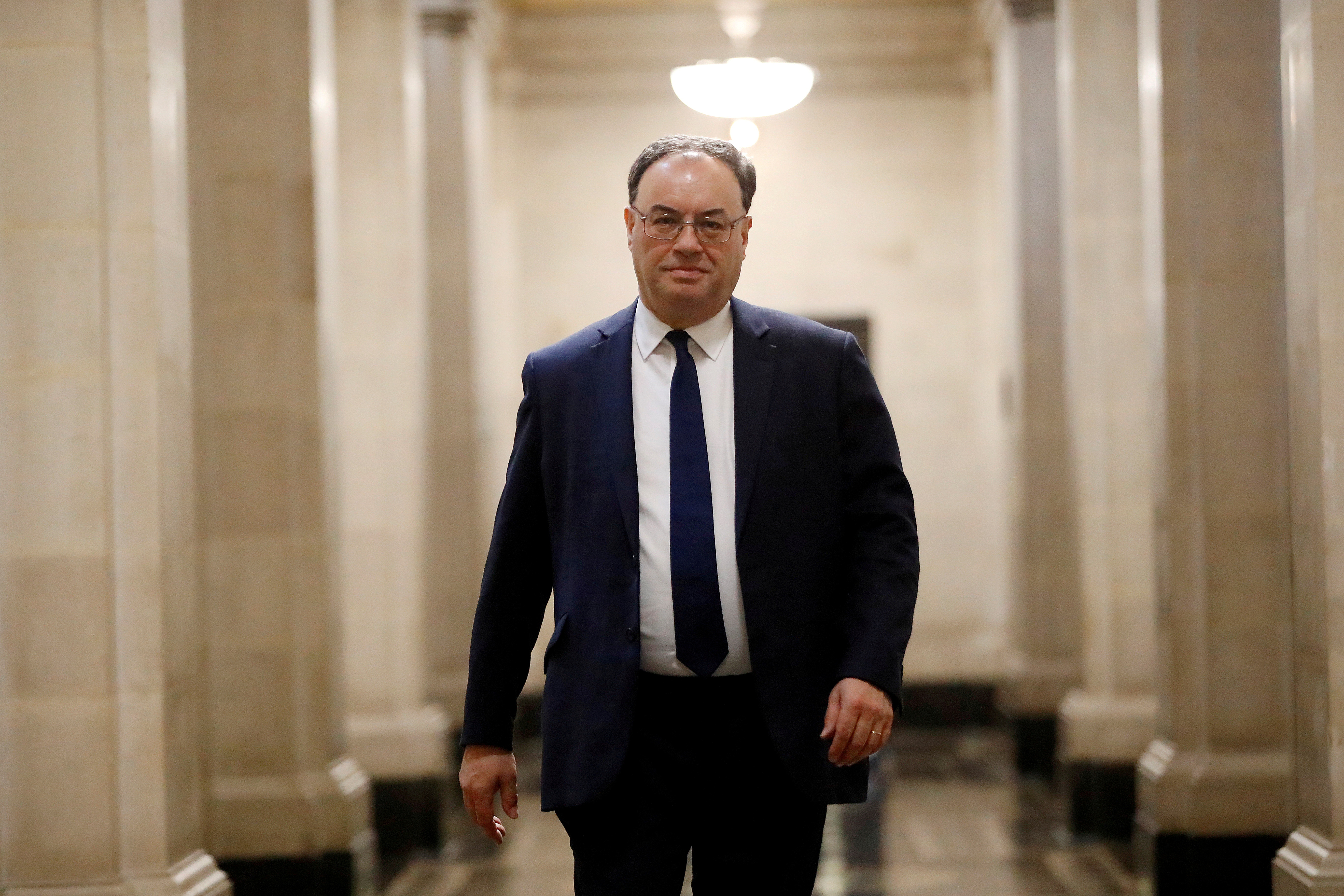 Bank of England Governor Andrew Bailey poses for a photograph on the first day of his new role at the Central Bank in London