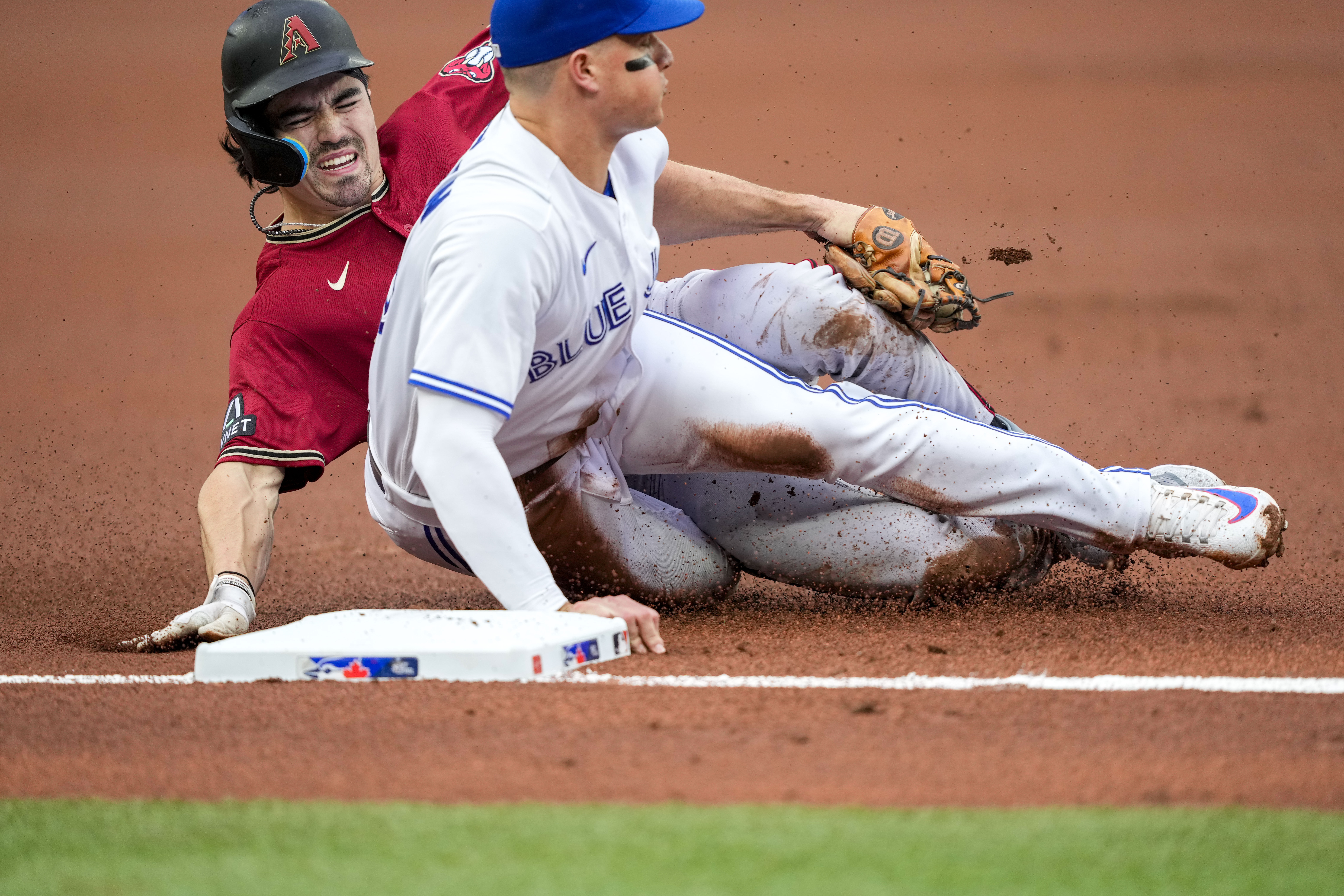 TORONTO, ON - AUGUST 25: Toronto Blue Jays Center field Kevin Pillar (11)  slides back to First during in the MLB game between the Philadelphia  Phillies and the Toronto Blue Jays at