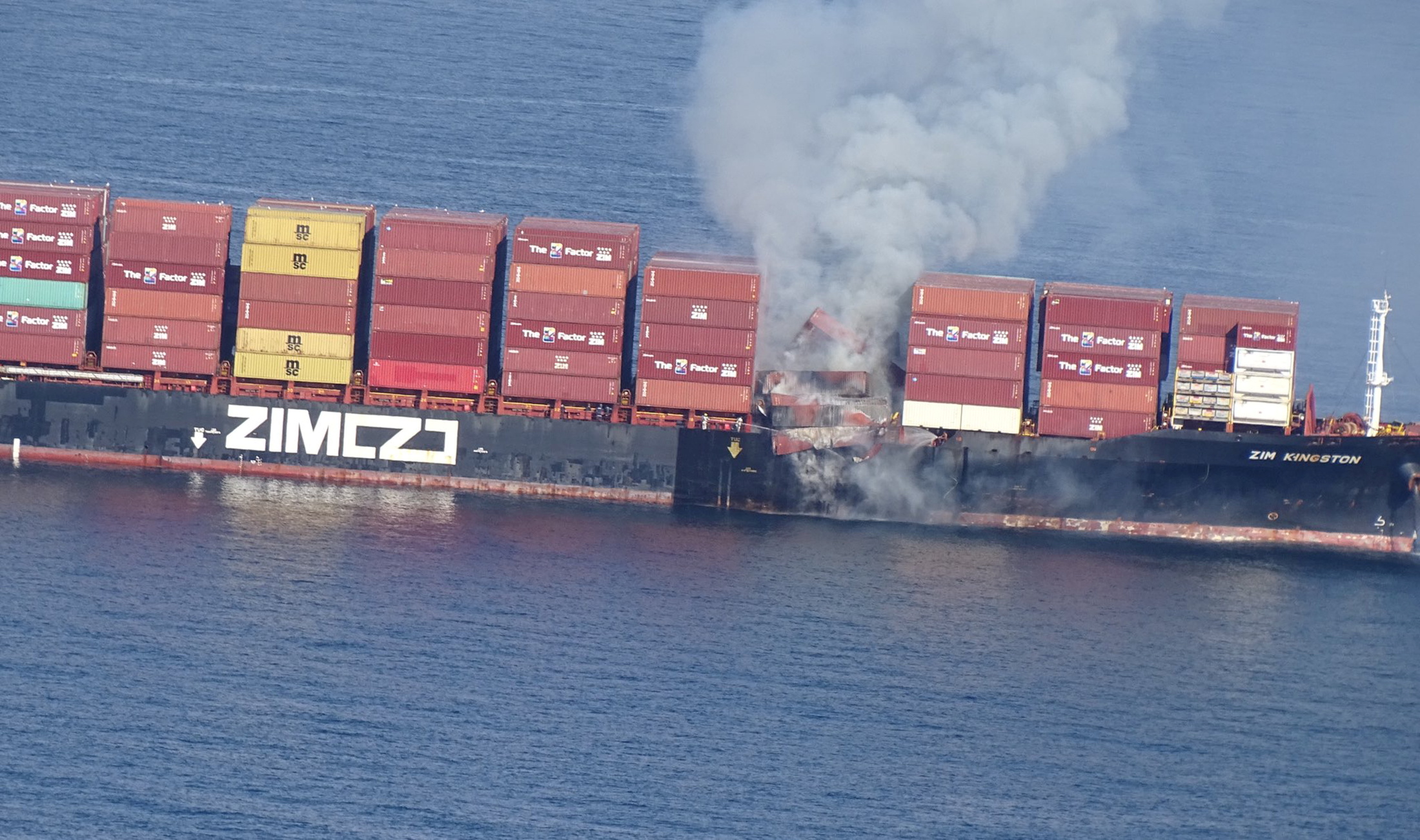 The container ship Zim Kingston burns from a fire off the coast of Victoria