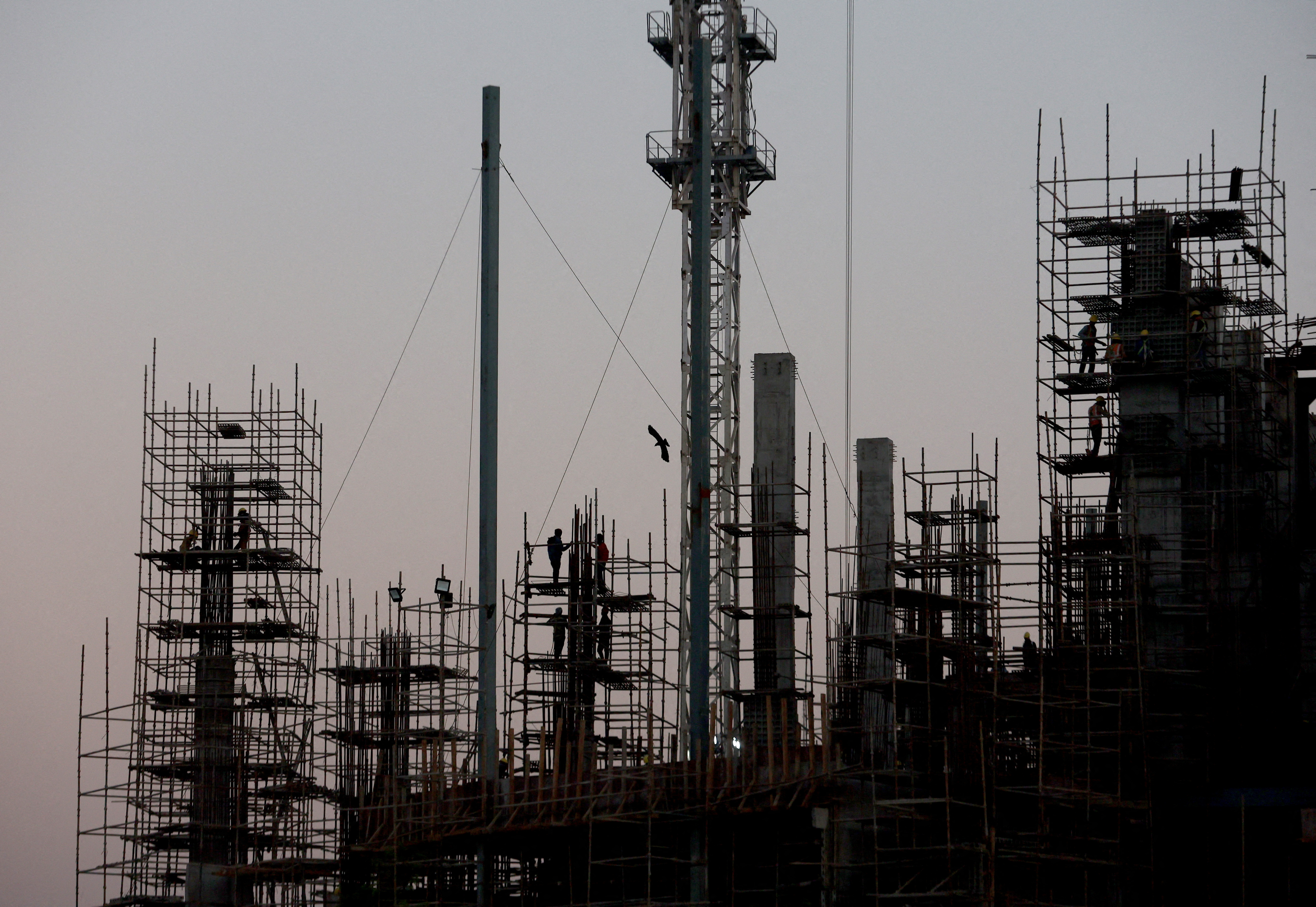 Labourers work at the construction site of a commercial building in New Delhi