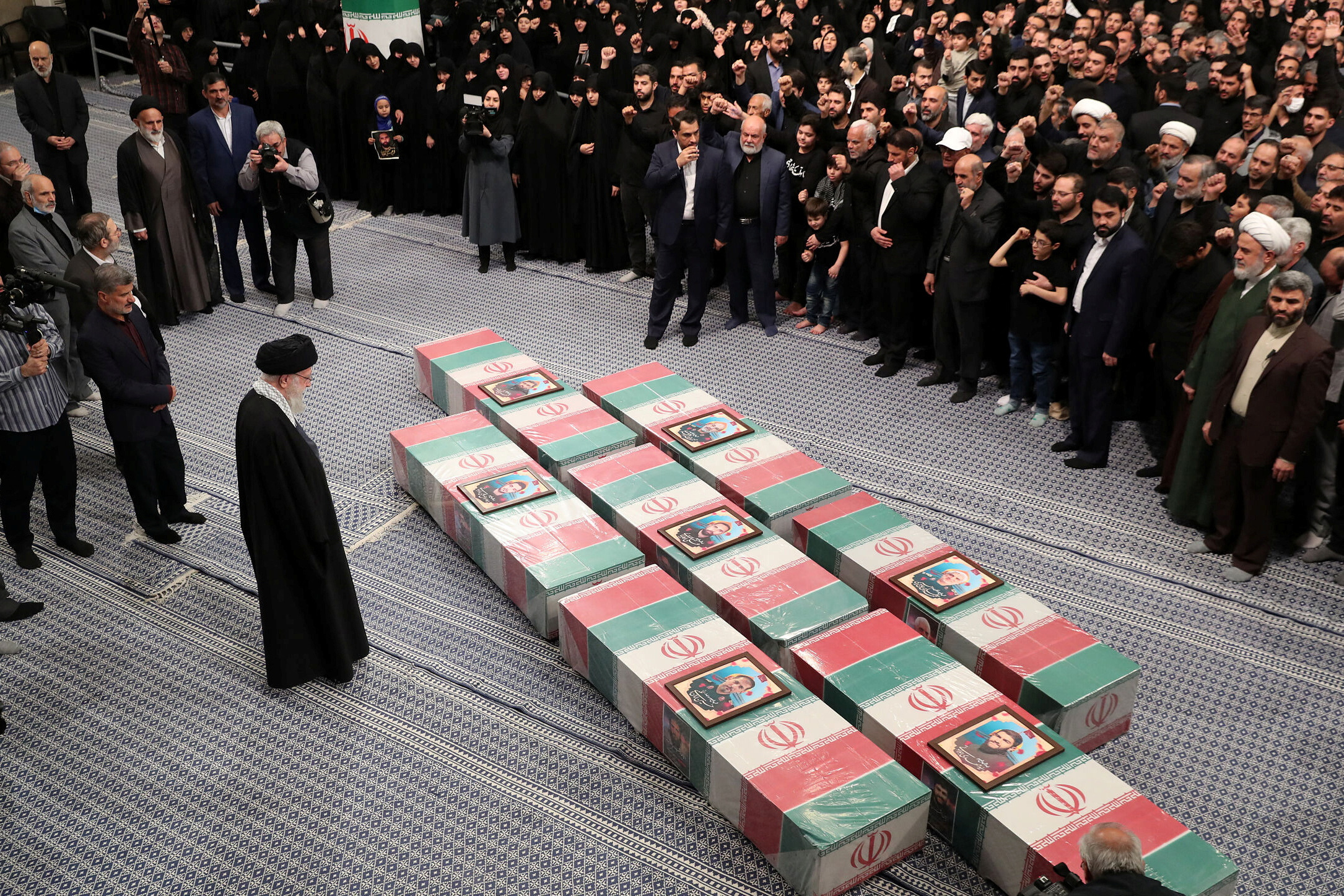 Iran's Supreme Leader, Ayatollah Ali Khamenei looks at the coffins of members of the Islamic Revolutionary Guard Corps, in Tehran