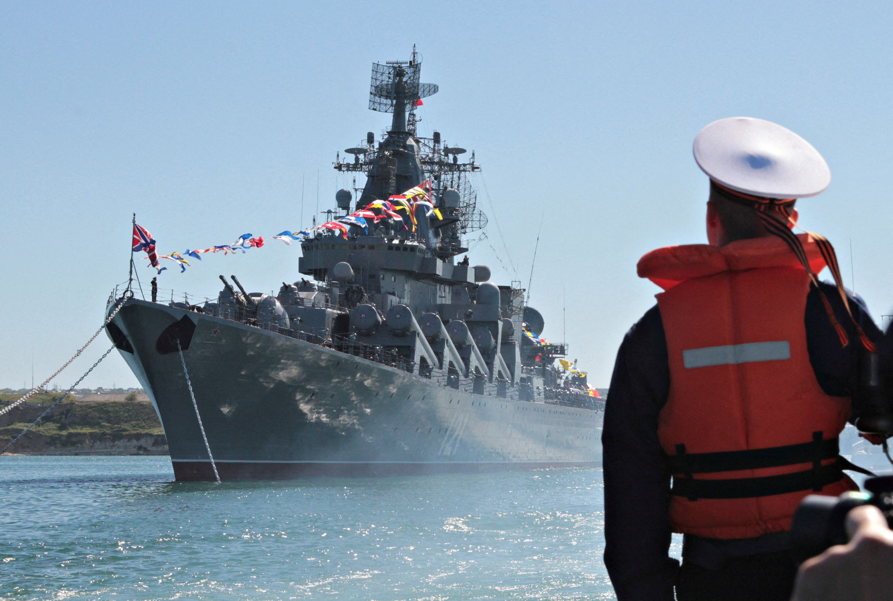 A sailor looks at the Russian missile cruiser Moskva moored in the Ukrainian Black Sea port of Sevastopol