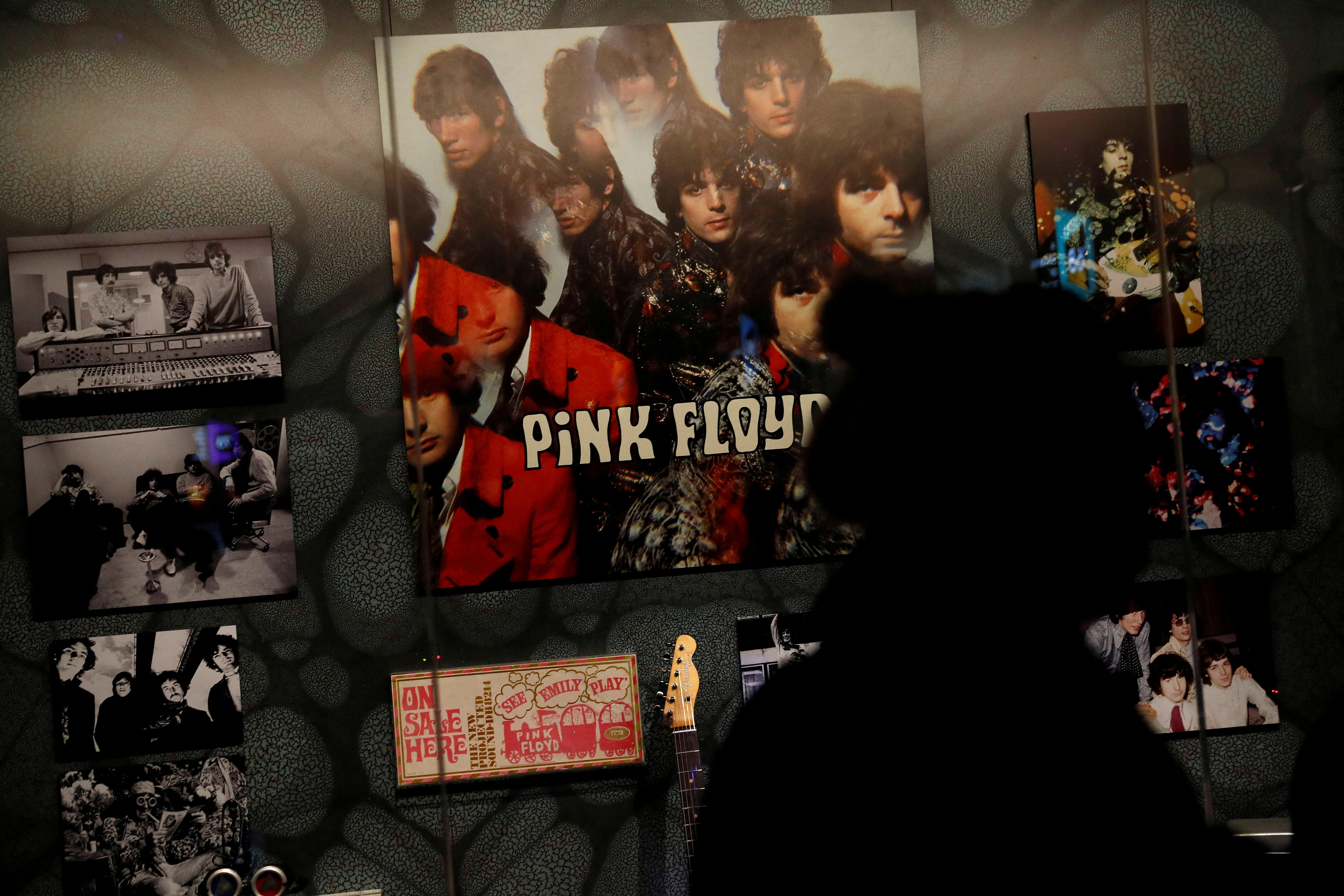 A woman is silhouetted at The Pink Floyd Exhibition: Their Mortal Remains at the V&A Museum in London