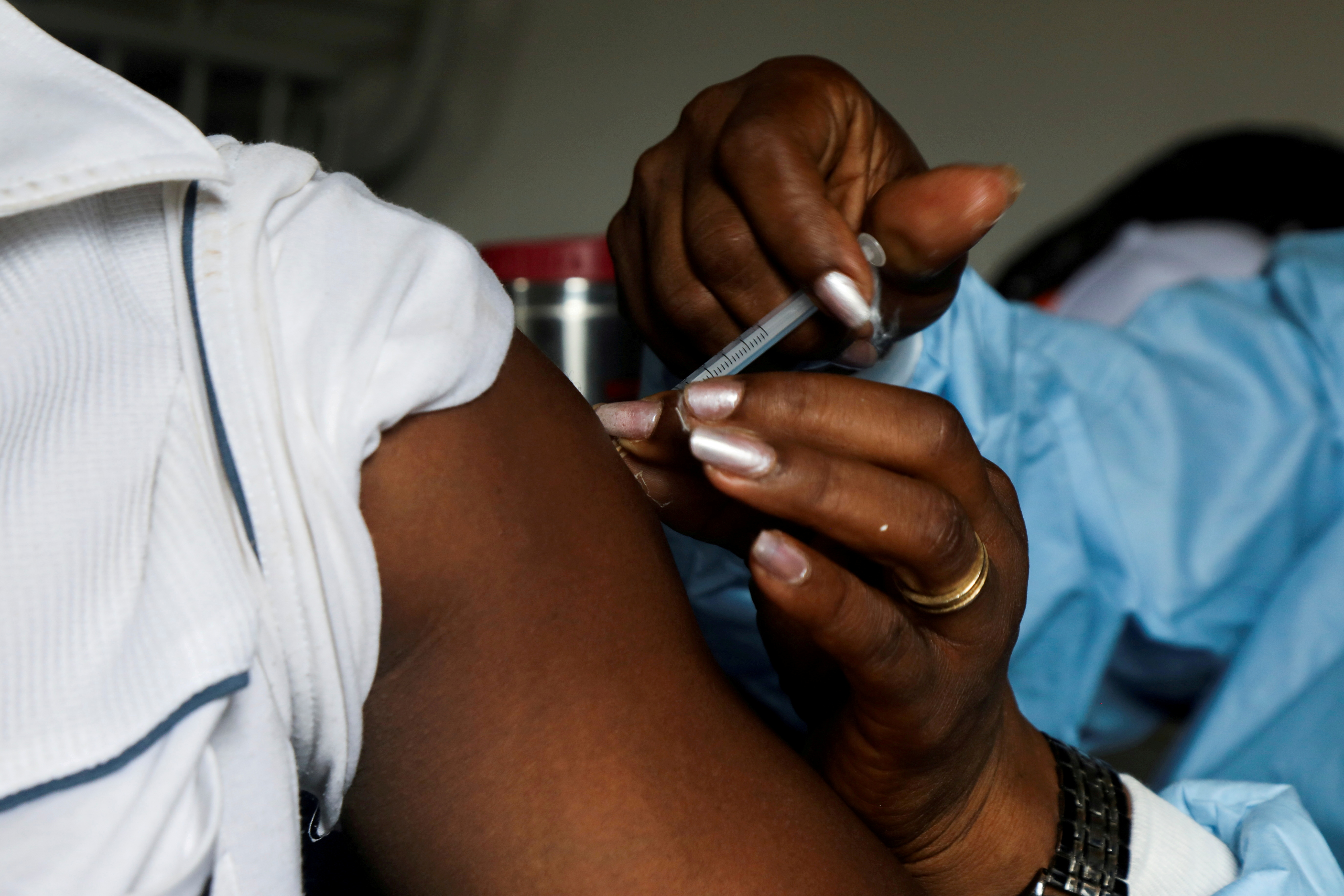   A man receives a vaccine against the coronavirus disease (COVID-19) in a vaccination truck at a mobile vaccination center in Abidjan, Ivory Coast September 23, 2021. REUTERS/Luc Gnago/File Photo