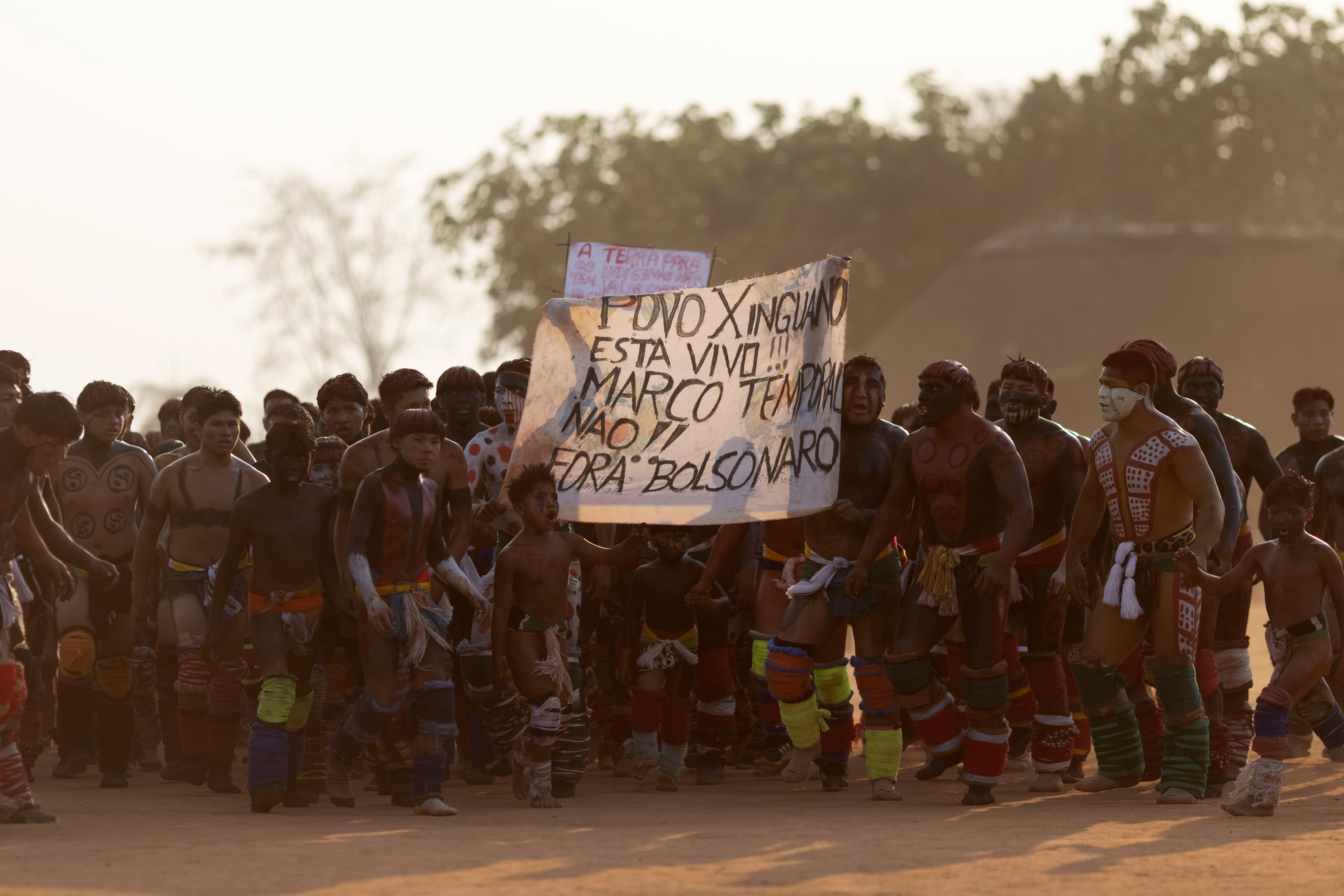 Yawalapiti men take part in a protest against Brazilian President Jair Bolsonaro during the Kuarup funeral ritual to honor the memory of Cacique Aritana, at Xingu Indigenous Park