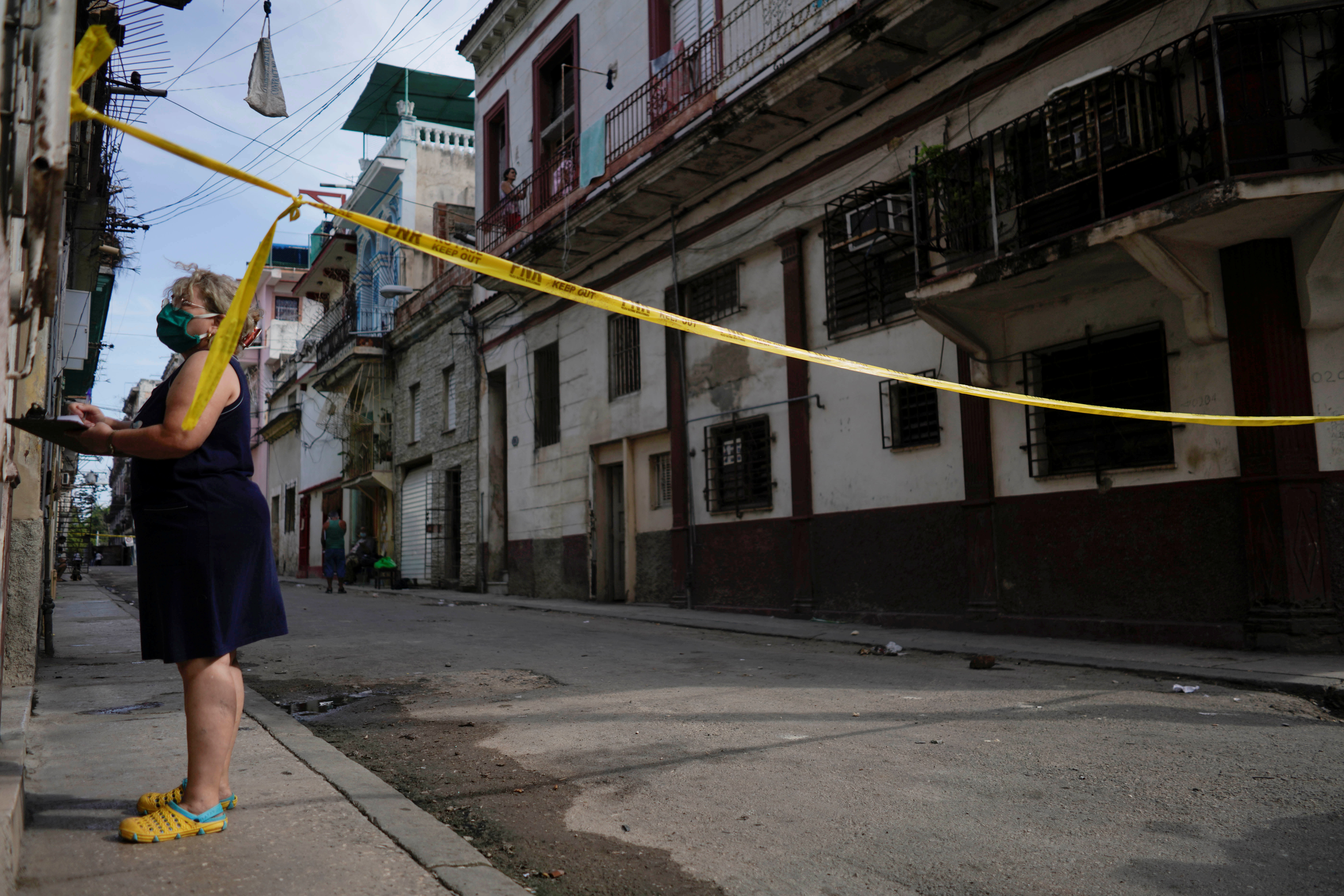 A health worker asks questions in a quarantine area amid concerns about the spread of the coronavirus disease (COVID-19) in Havana, Cuba, April 8, 2021. Picture taken April 8, 2021. REUTERS/Alexandre Meneghini