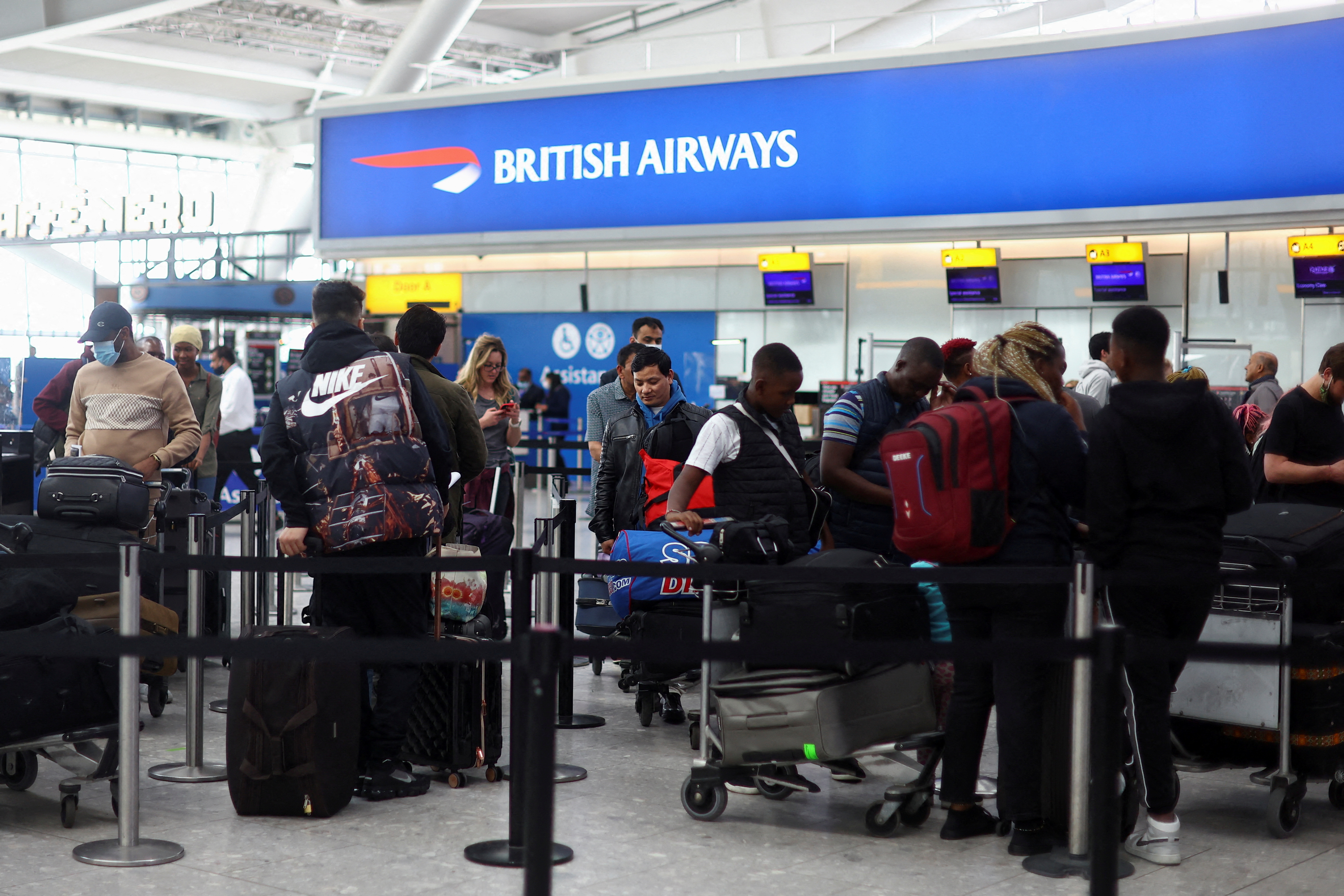 People prepare to travel for Easter Bank Holiday weekend, at Heathrow Airport in London, Britain