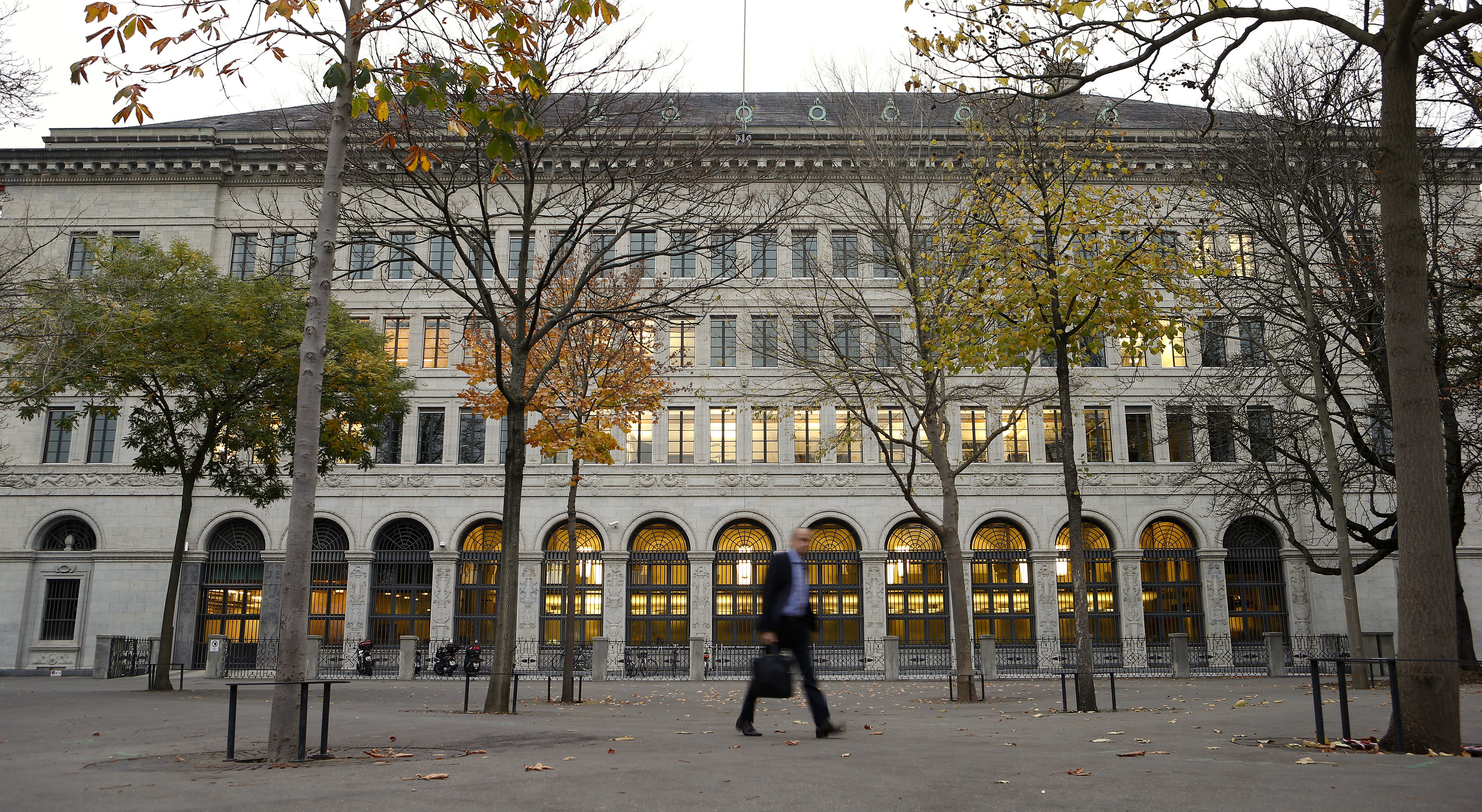 A man walks past the Swiss National Bank building in Zurich