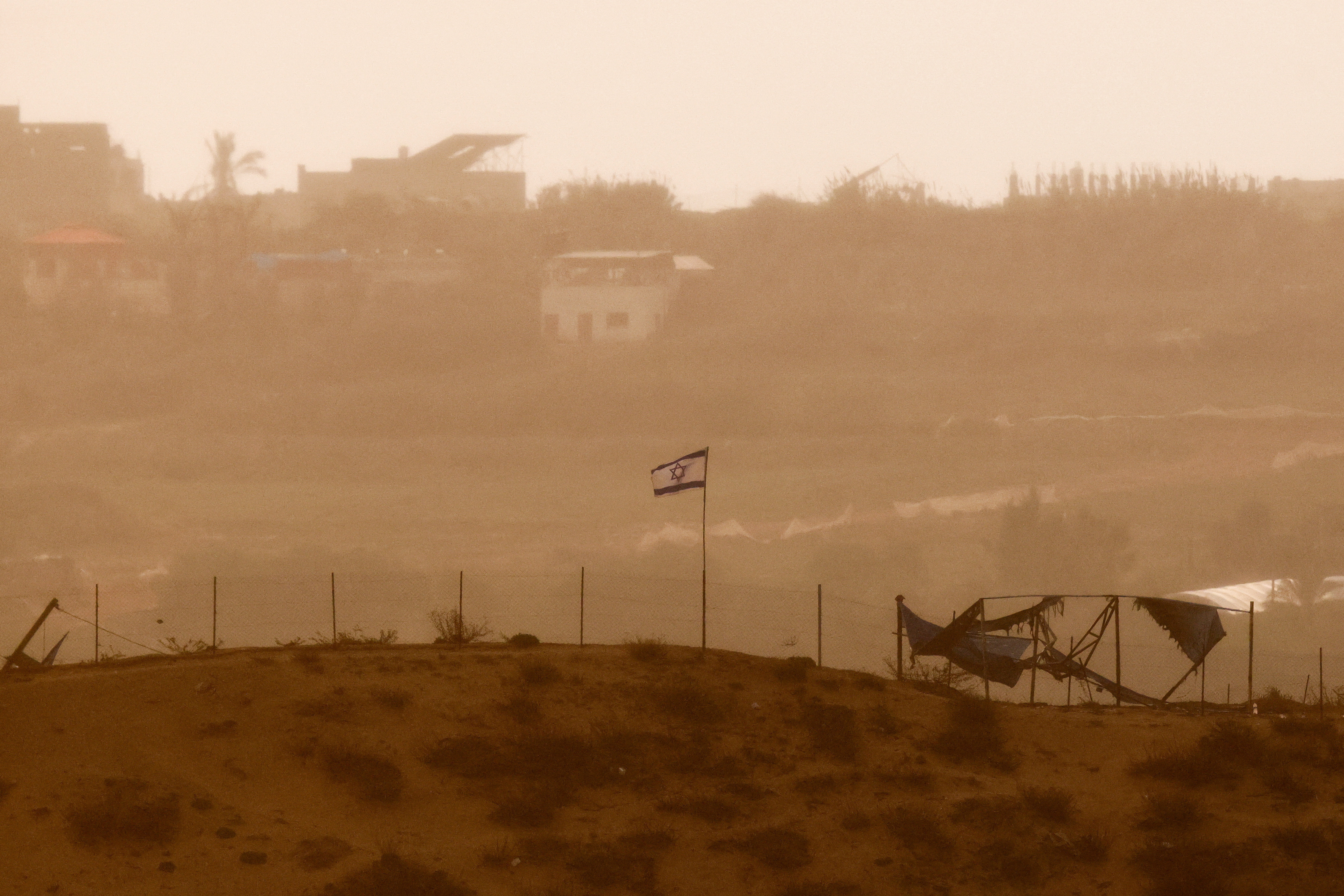 Israeli flag flutters in north Gaza, as seen from Israel