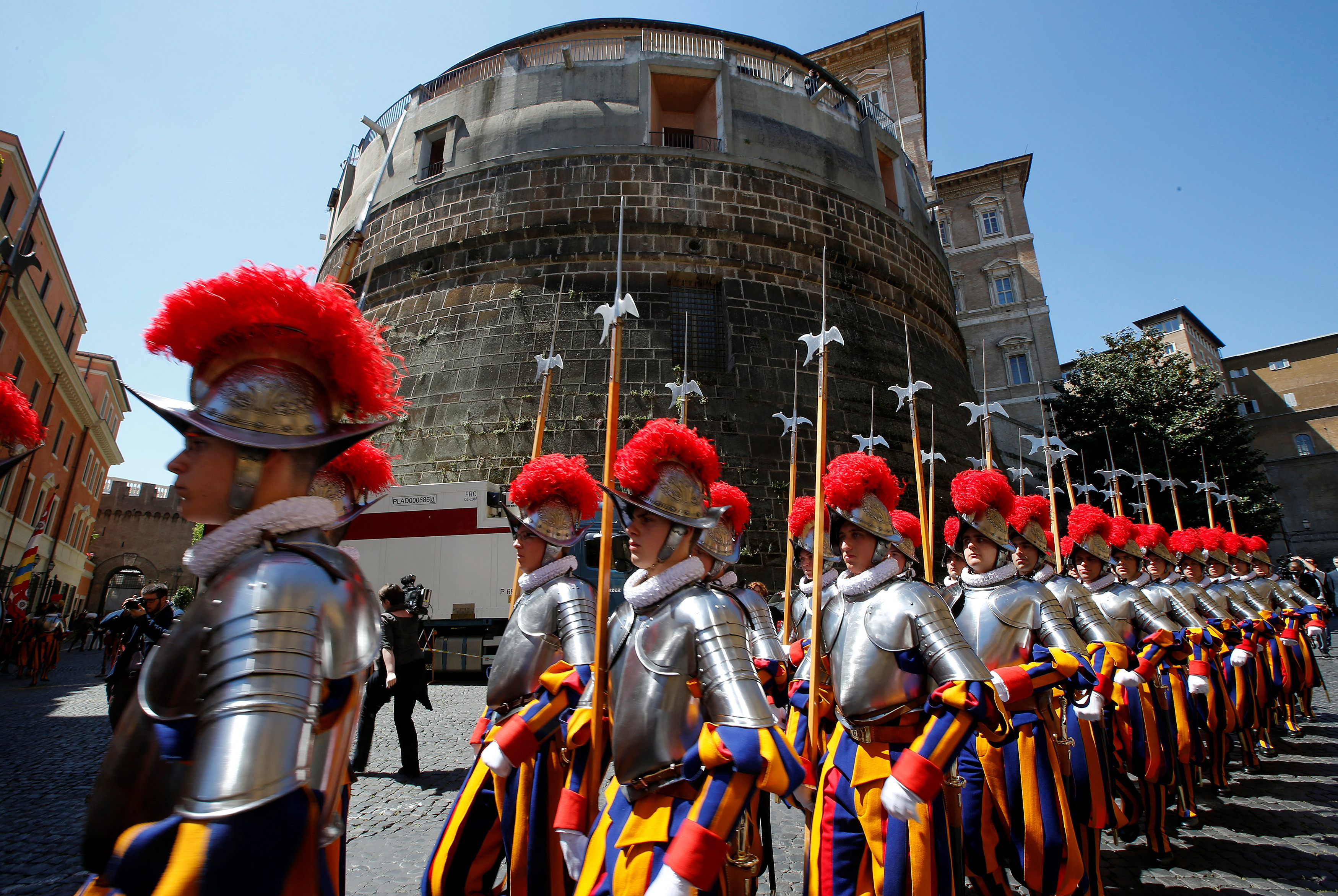 The Vatican's elite Swiss Guards march in front of the Vatican bank tower at the Vatican