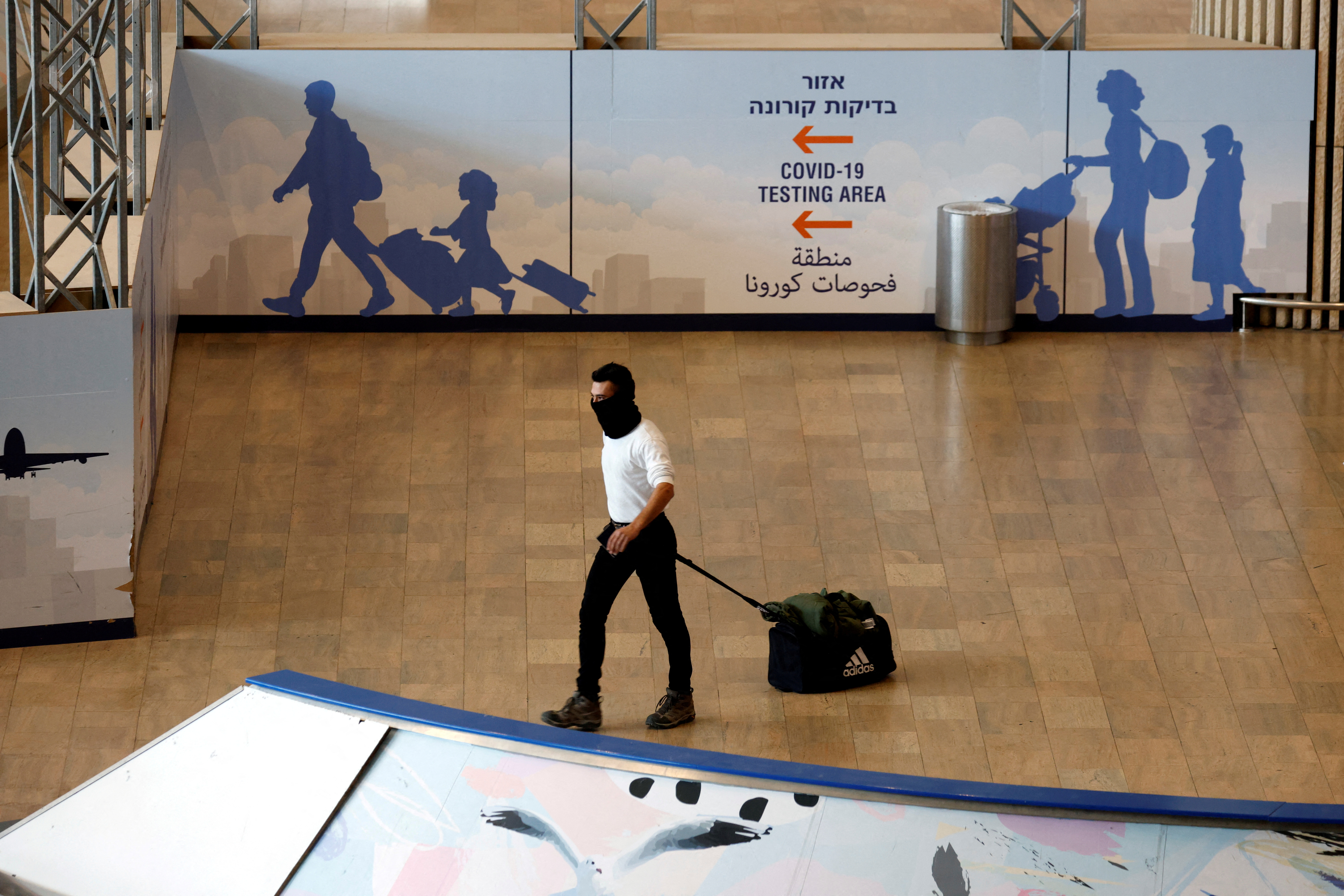 A traveller walks towards the coronavirus disease (COVID-19) pandemic testing area at Ben Gurion International Airport