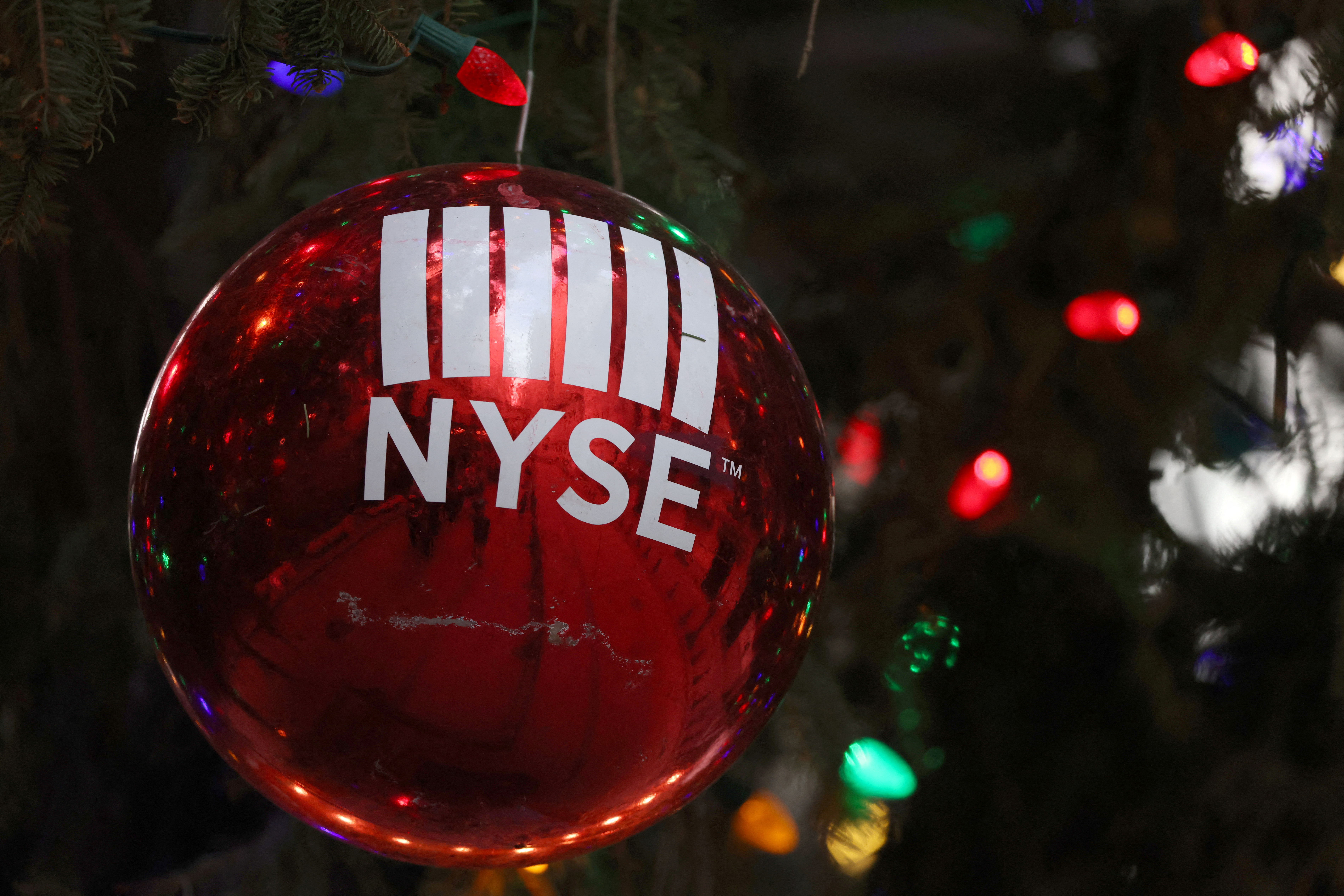 A decoration hangs on a Christmas tree outside the New York Stock Exchange (NYSE) on the last day of trading before Christmas in Manhattan, New York City, U.S., December 23, 2021. REUTERS/Andrew Kelly