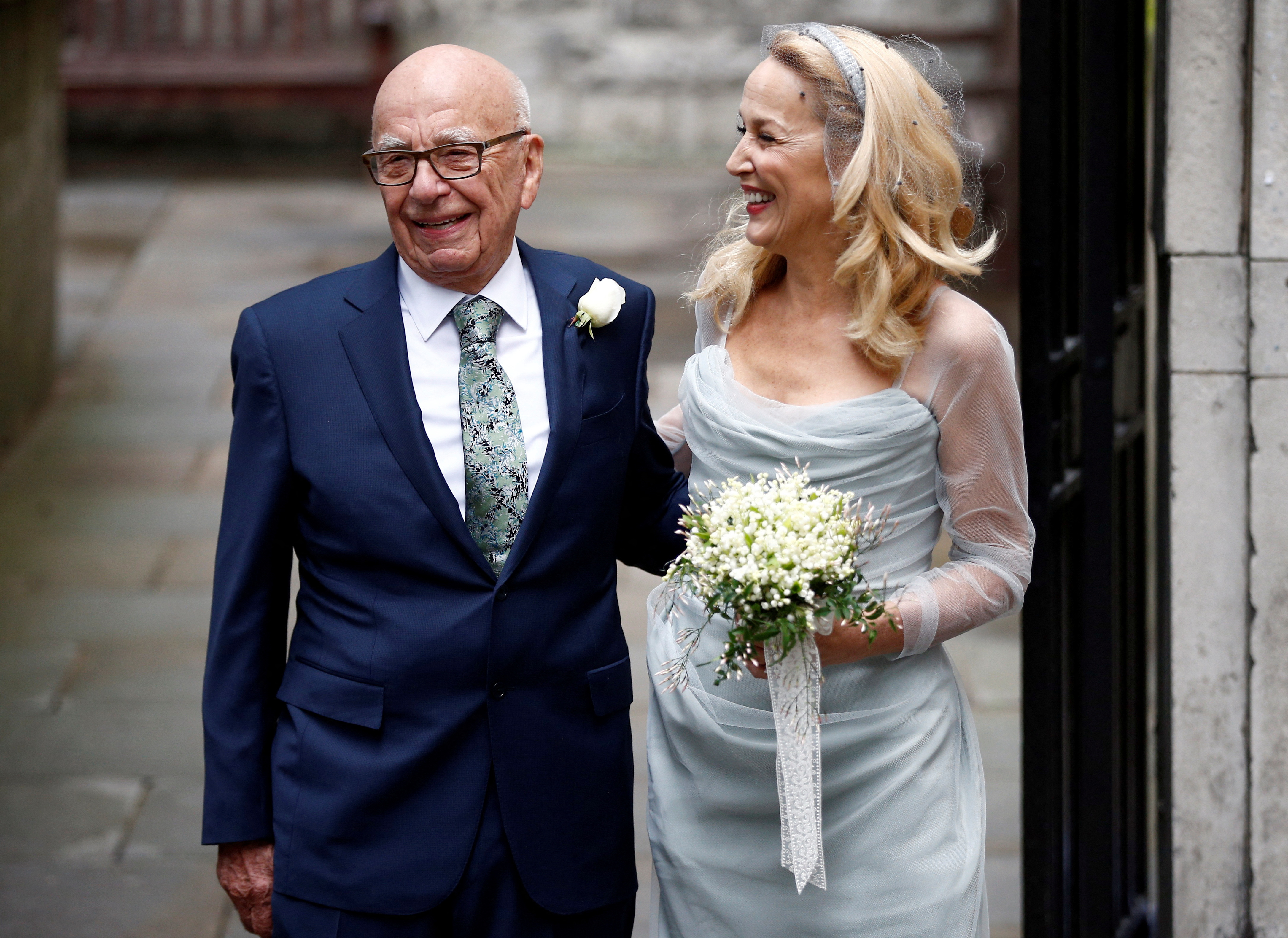 Media Mogul Rupert Murdoch and former supermodel Jerry Hall pose for a photograph outside St Bride's church following a service to celebrate their wedding which took place on Friday, in London