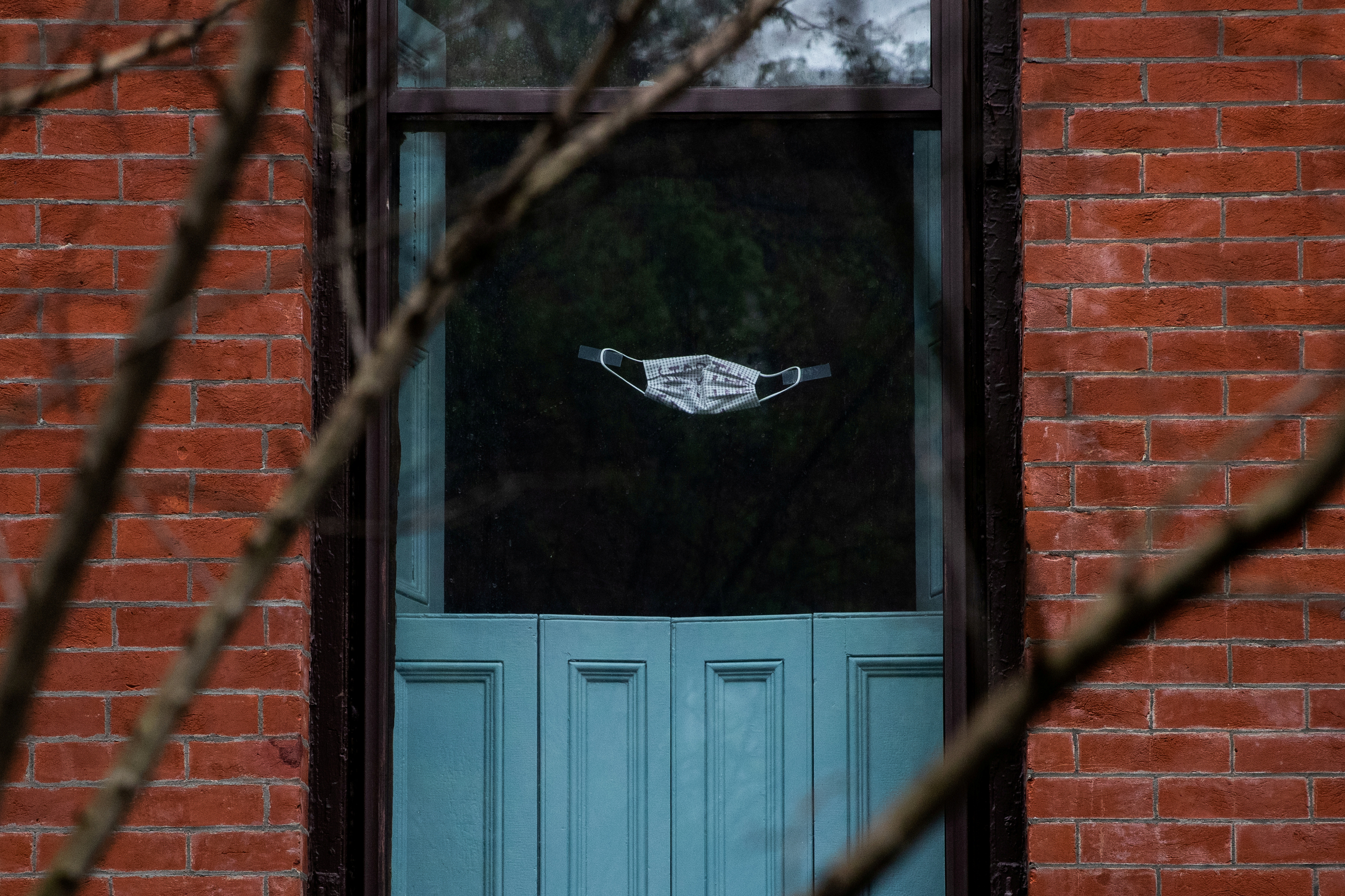 A protective mask is seen on a window during the outbreak of the coronavirus disease (COVID-19) in the Brooklyn borough of New York City, U.S., April 26, 2020. REUTERS/Jeenah Moon     