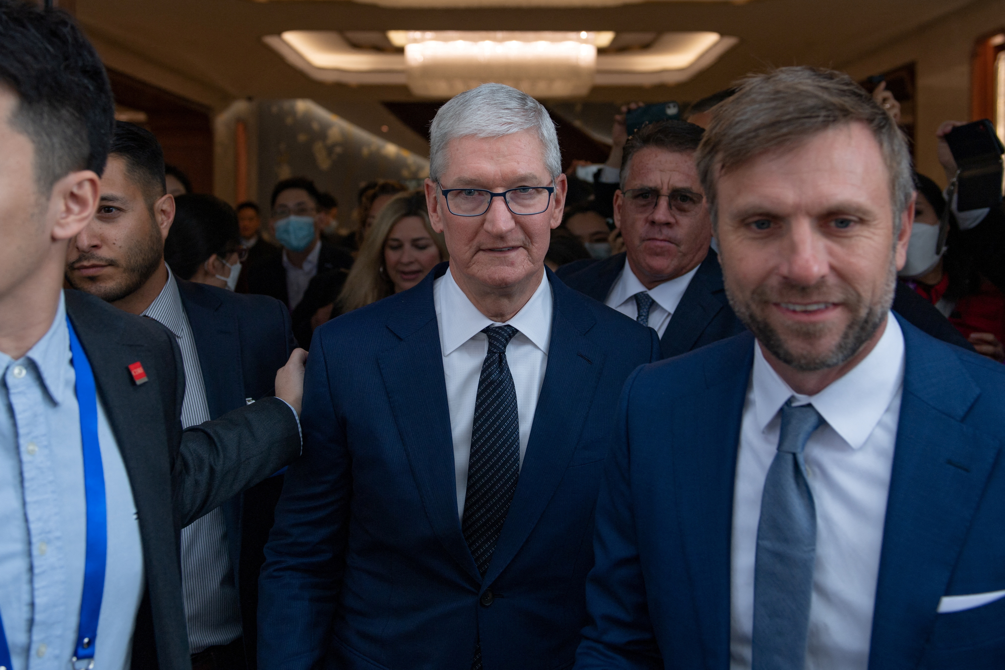 Apple's CEO Tim Cook leaves the venue following his speech at the China Development Forum 2023, in Beijing