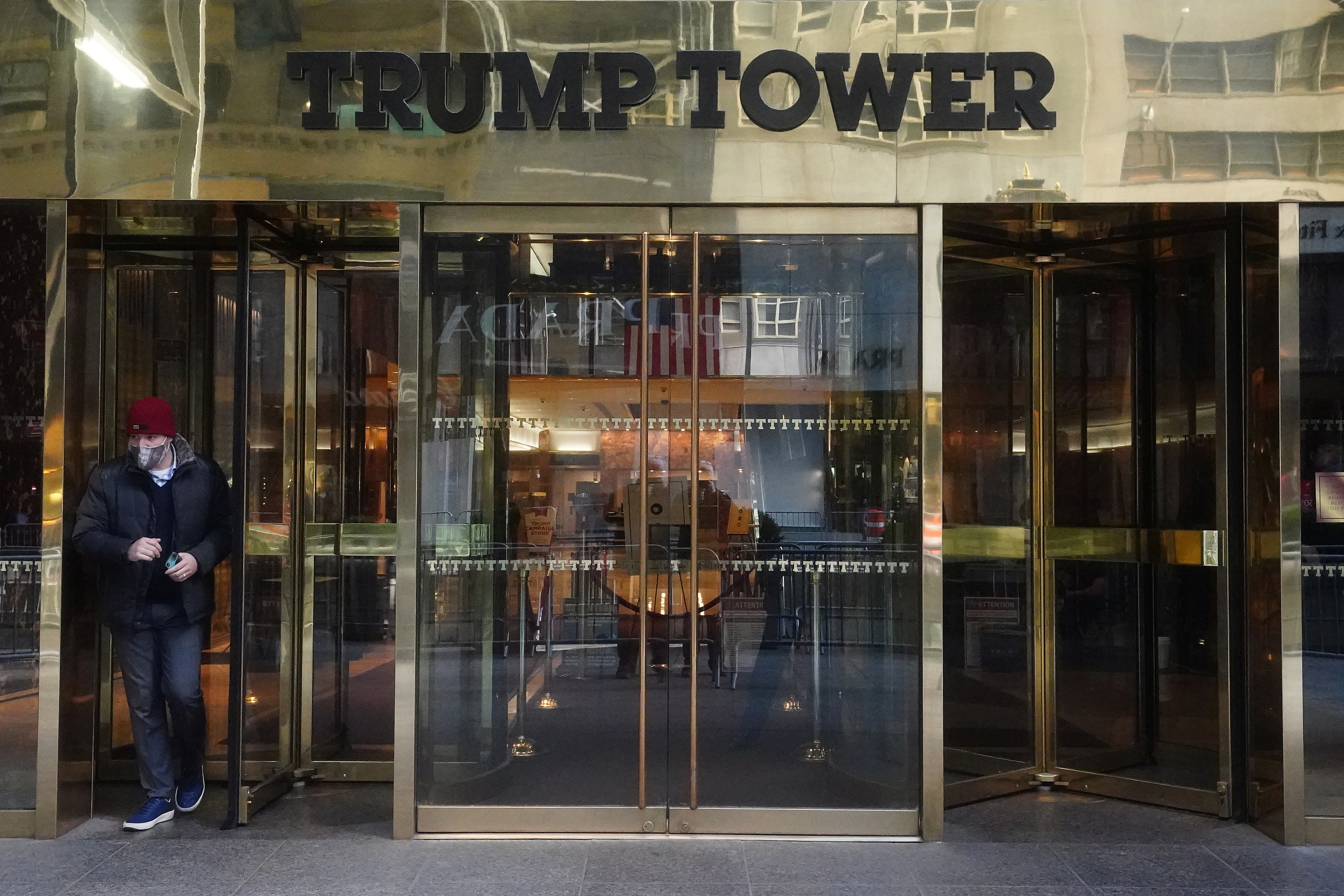 A person walks out of Trump Tower in New York