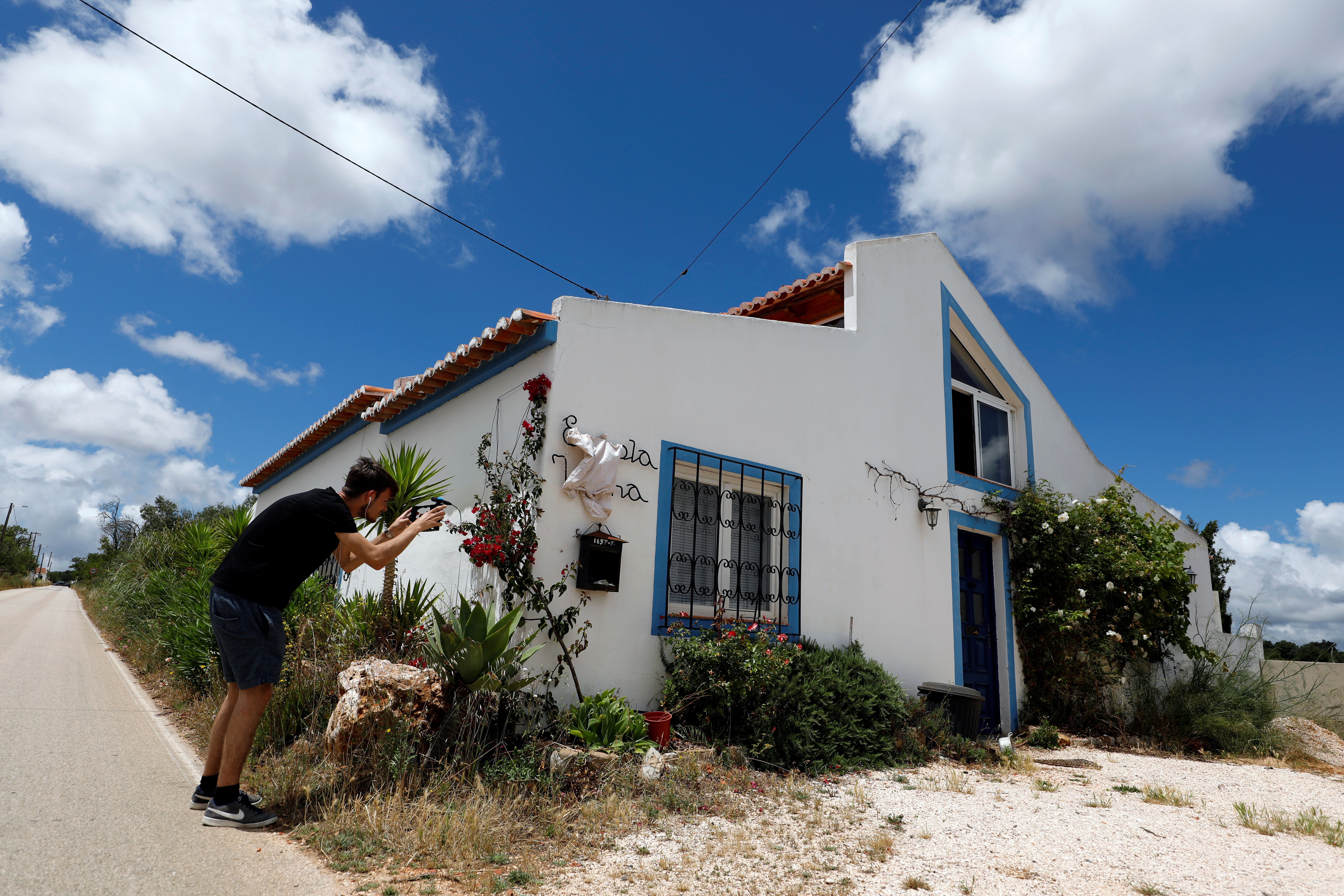 A reporter takes a picture of the house where the suspect lived when Madeleine McCann disappeared in 2007, near Lagos