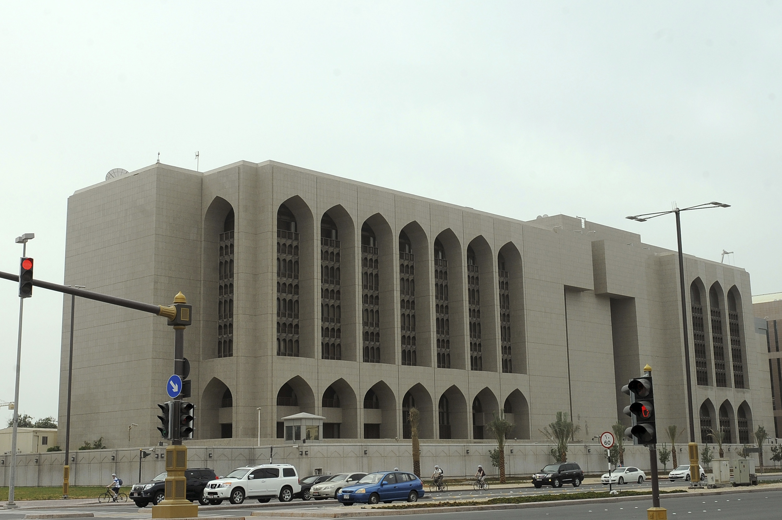 Vehicles stop at a red light in front of the main branch of UAE Central Bank in Abu Dhabi