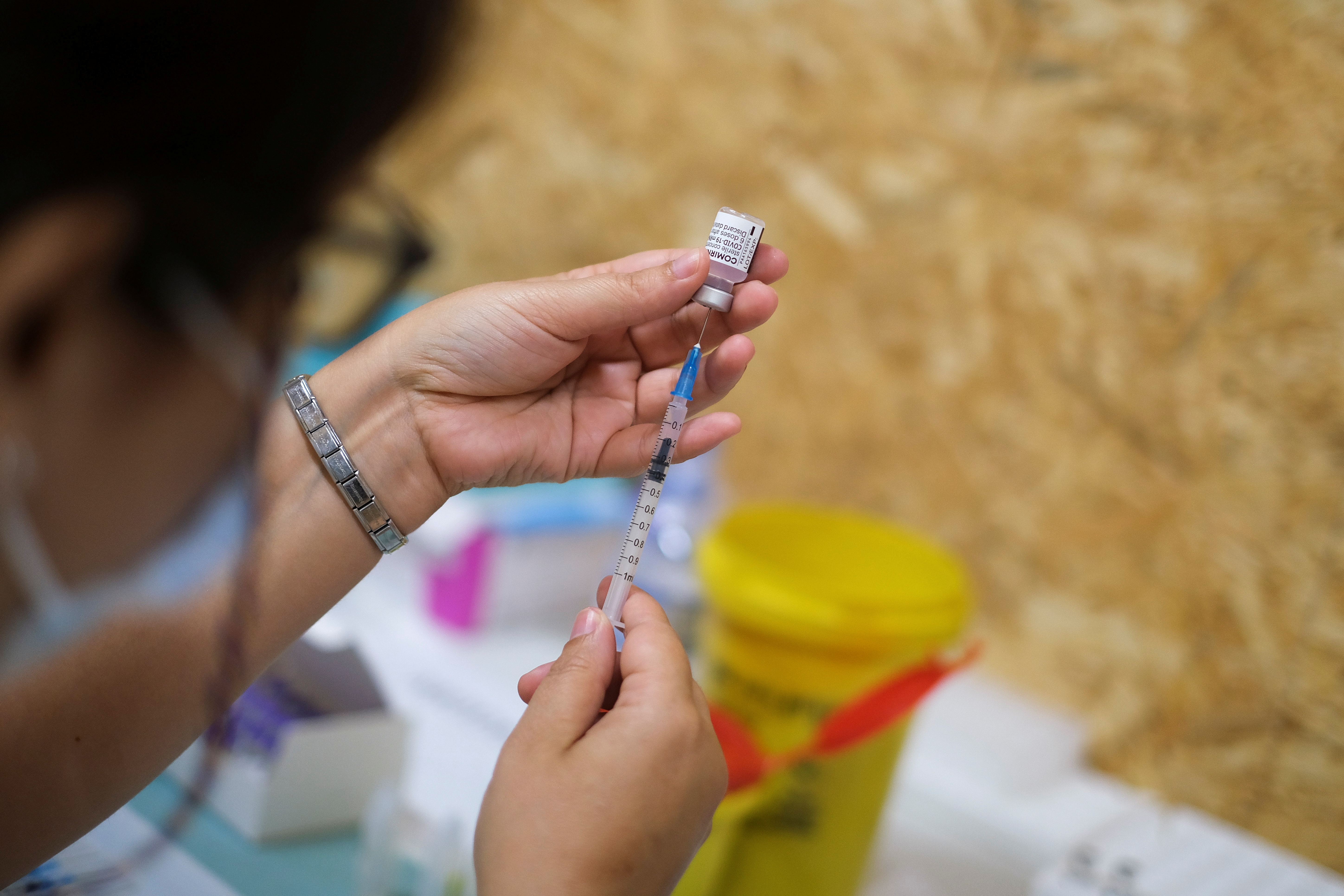 Healthcare worker prepares COVID-19 vaccine at a vaccination centre in Seixal
