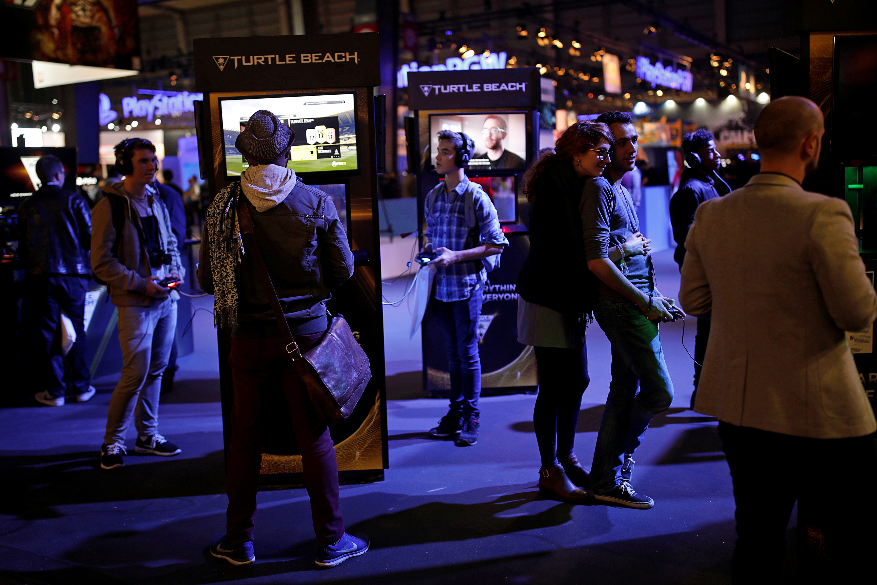 Visitors play video games with Turtle Beach headphones at the Paris Games Week, a trade fair for video games in Paris