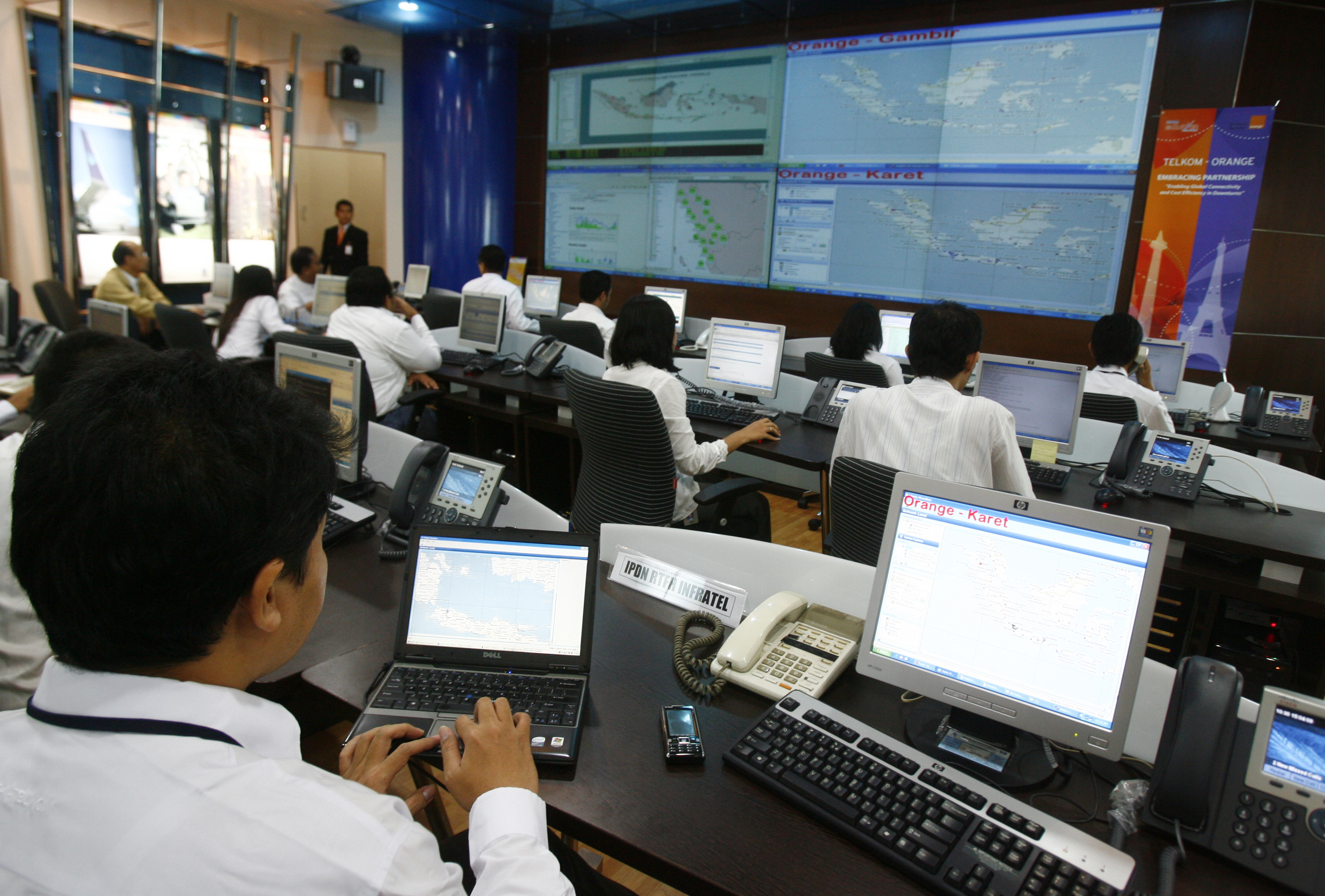 Workers of the Indonesia's leading telecommunication company PT TELKOM monitor the screen at the monitoring unit in Jakarta
