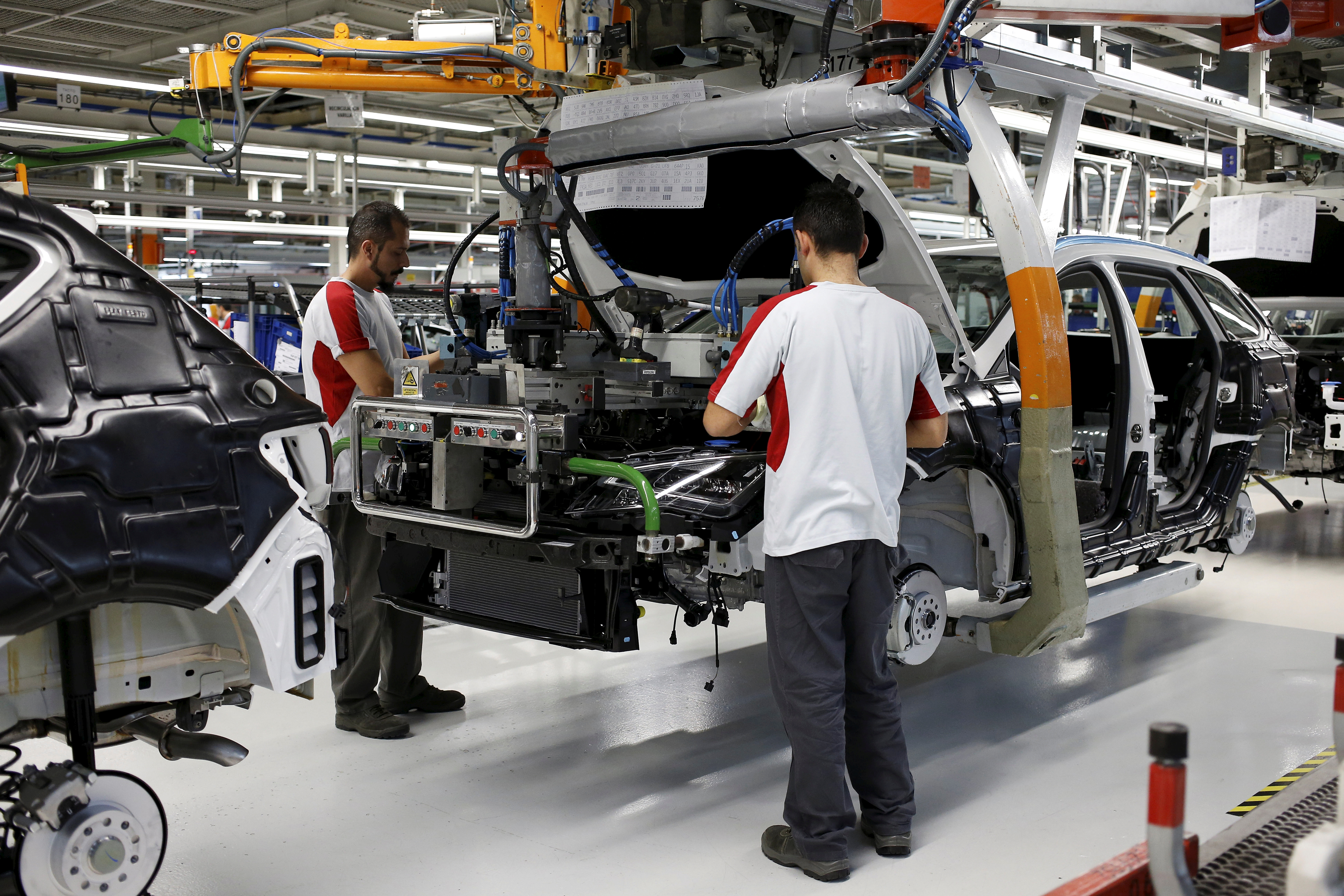 SEAT factory workers assemble a car in Martorell near Barcelona