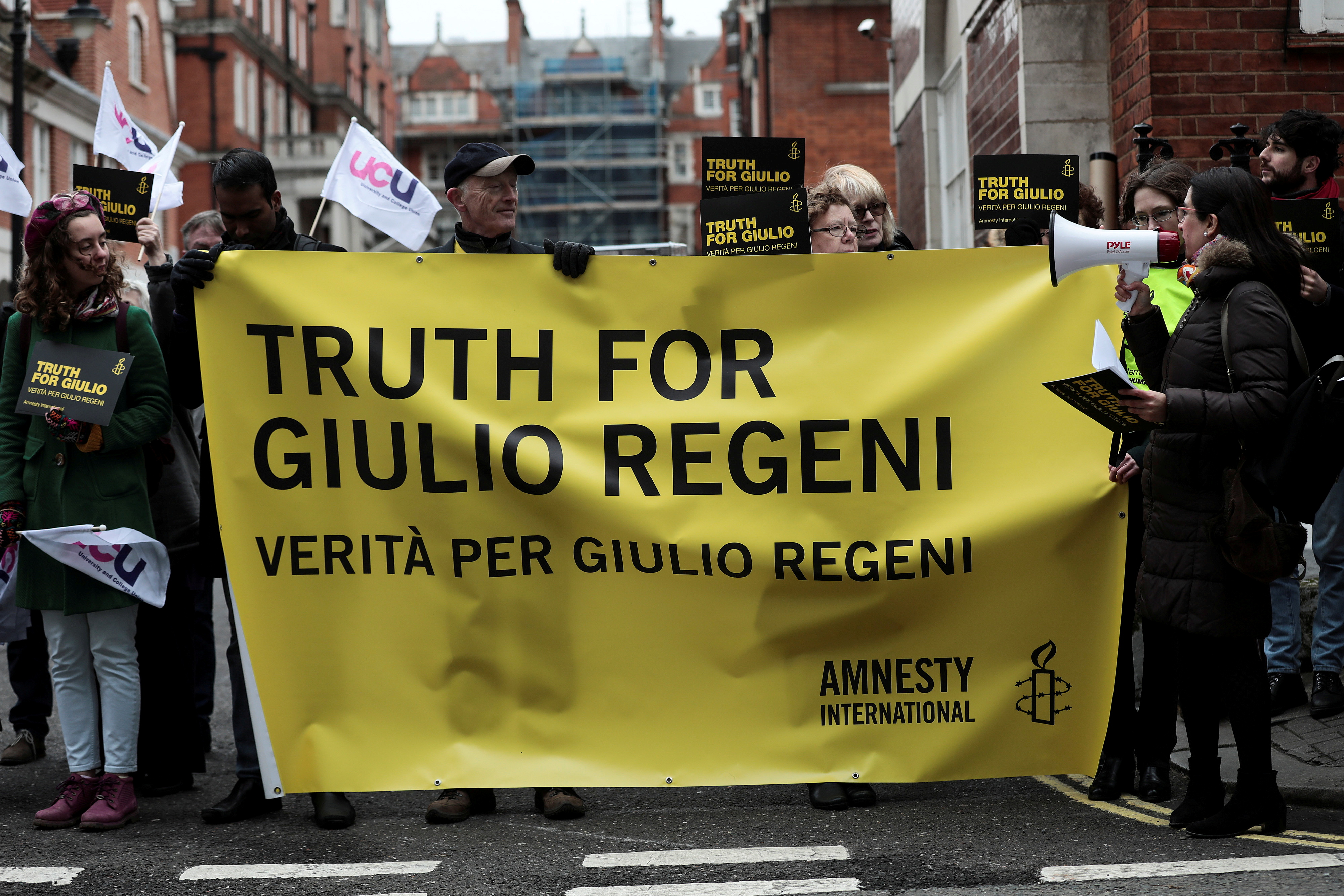 Demonstrators from Amnesty International hold placards outside the Egyptian embassy in support of Giulio Regeni, who was found murdered in Cairo two years ago, in London, Britain, February 2, 2018. REUTERS/Simon Dawson/File Photo