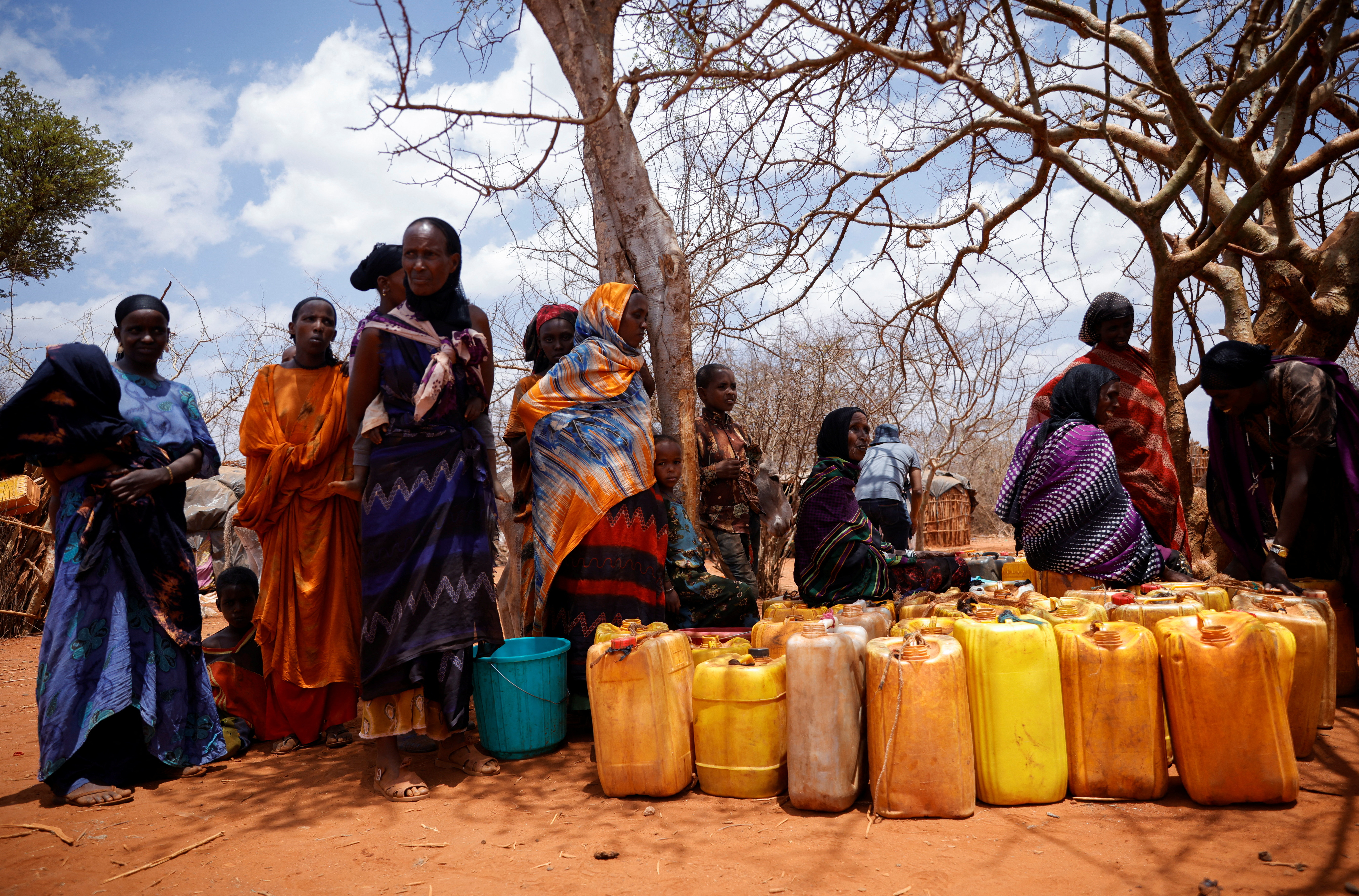 Women wait for a water truck in Kura Kalicha camp for the people internally displaced by drought near Das town