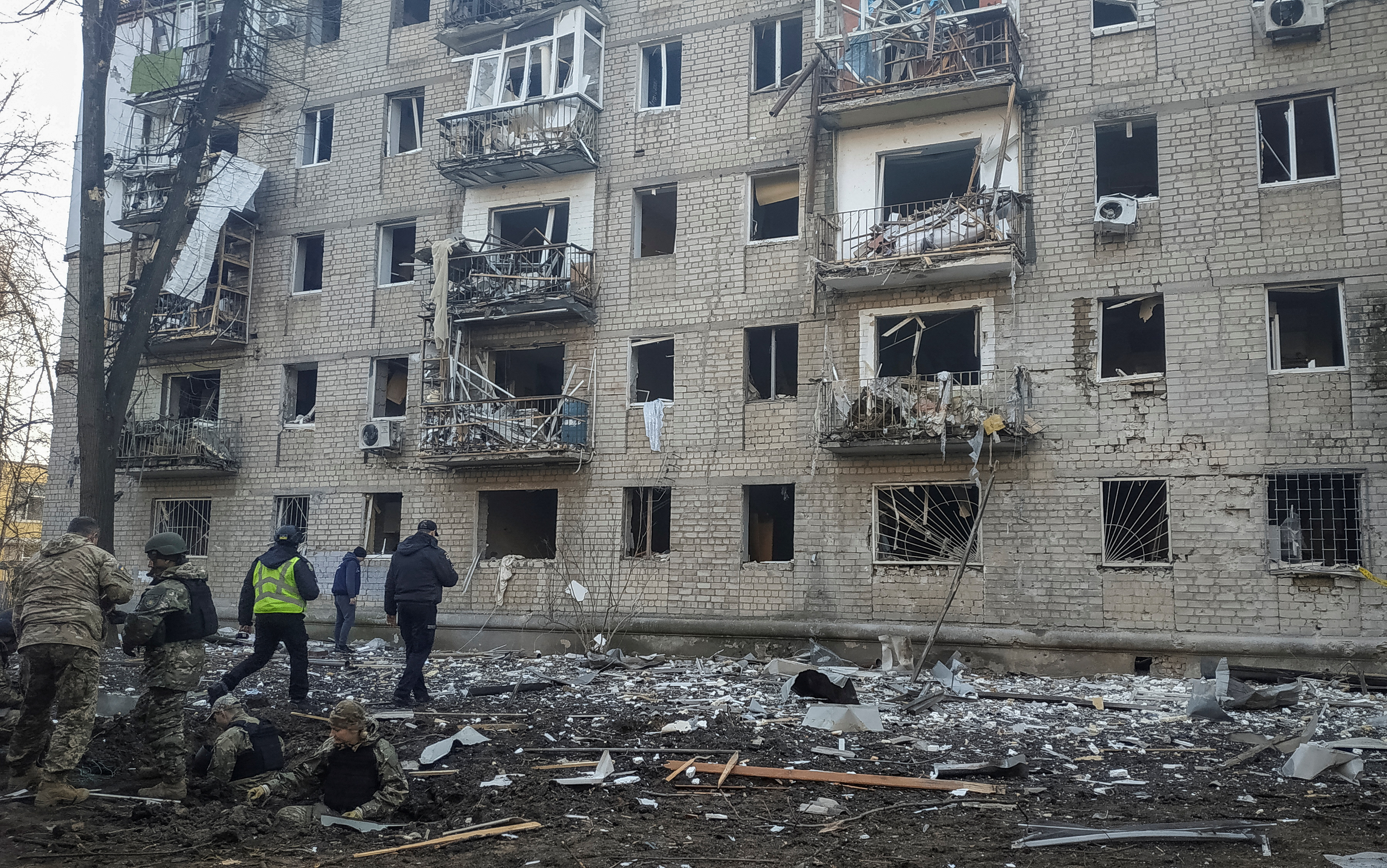 Police experts works at the site where buildings were damaged by a Russian military strike in Kharkiv
