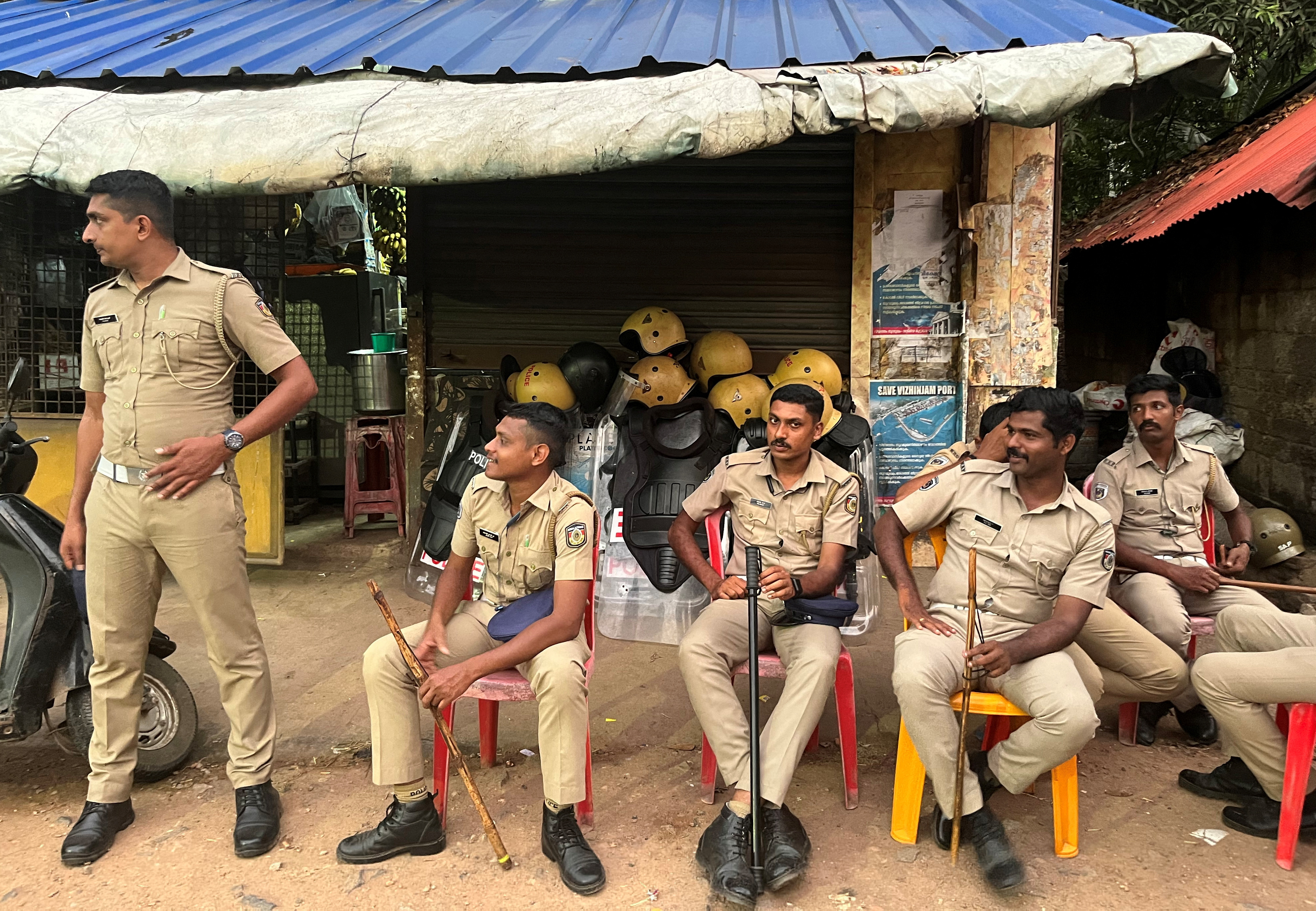 Policemen are deployed as people from the fishing community protest near the entrance of proposed Vizhinjam Port