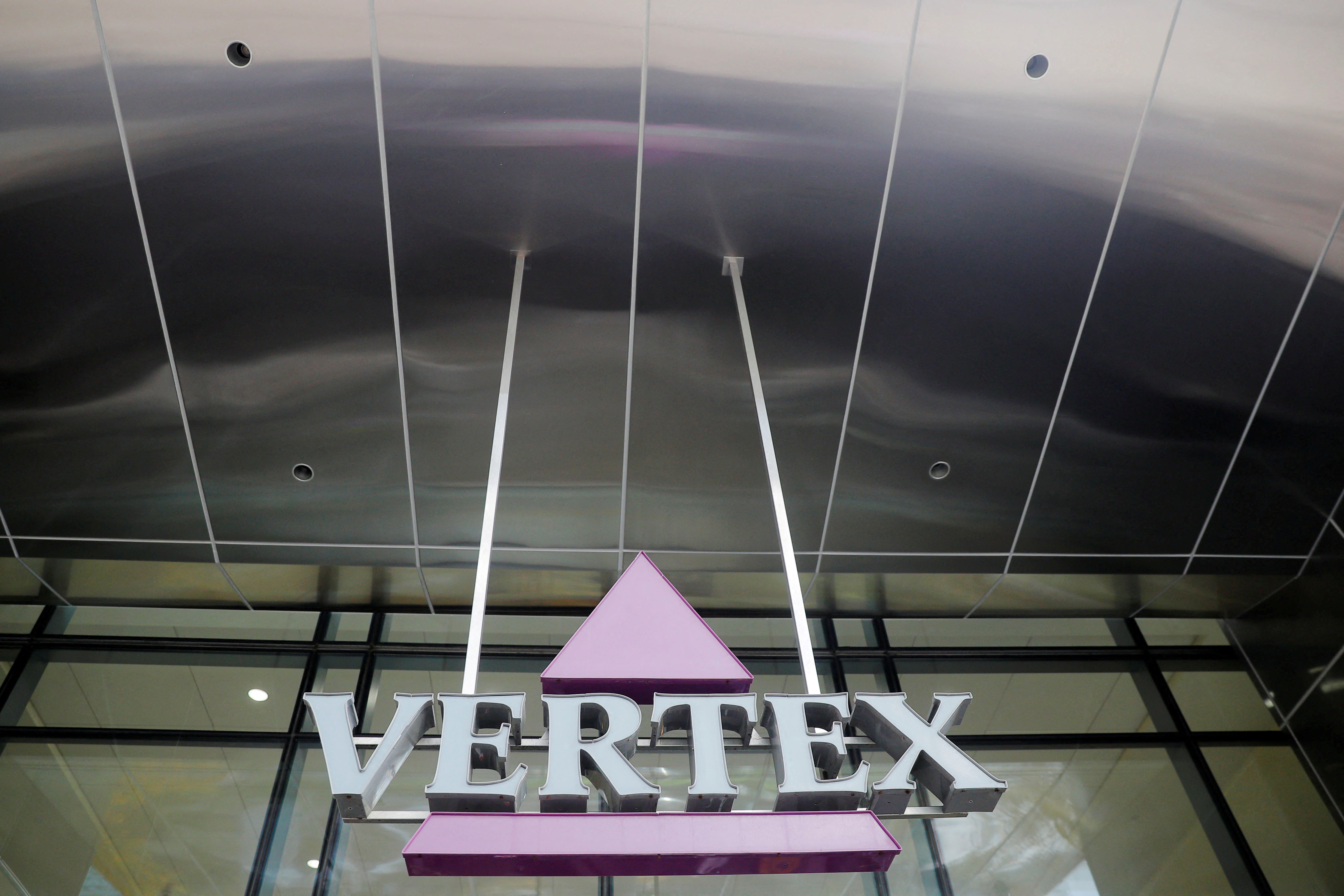A sign hangs in front of the world headquarters of Vertex Pharmaceuticals in Boston