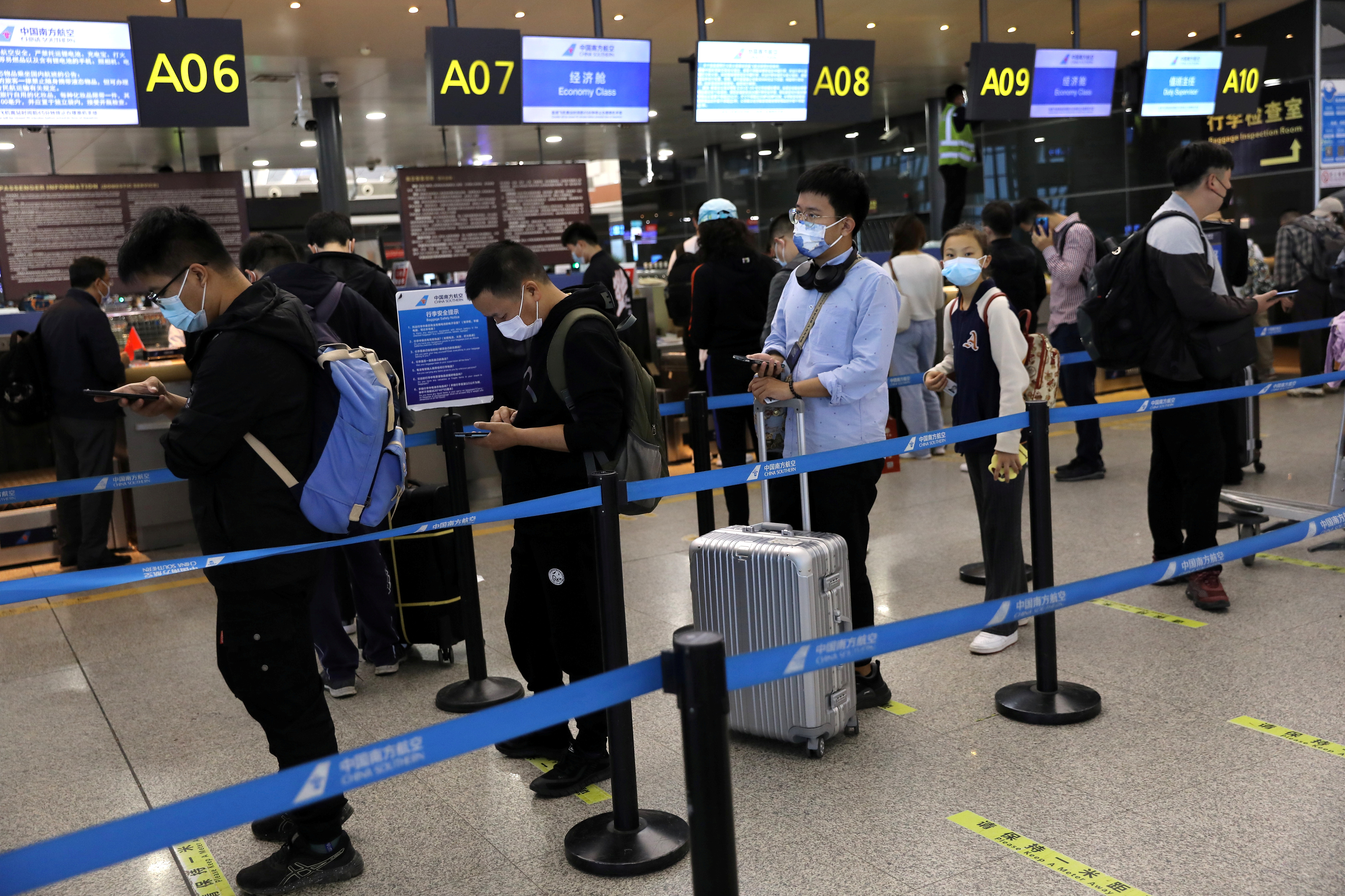 Travellers at Taoxian International Airport ahead of China's National Day and Golden Week holiday, in Shenyang